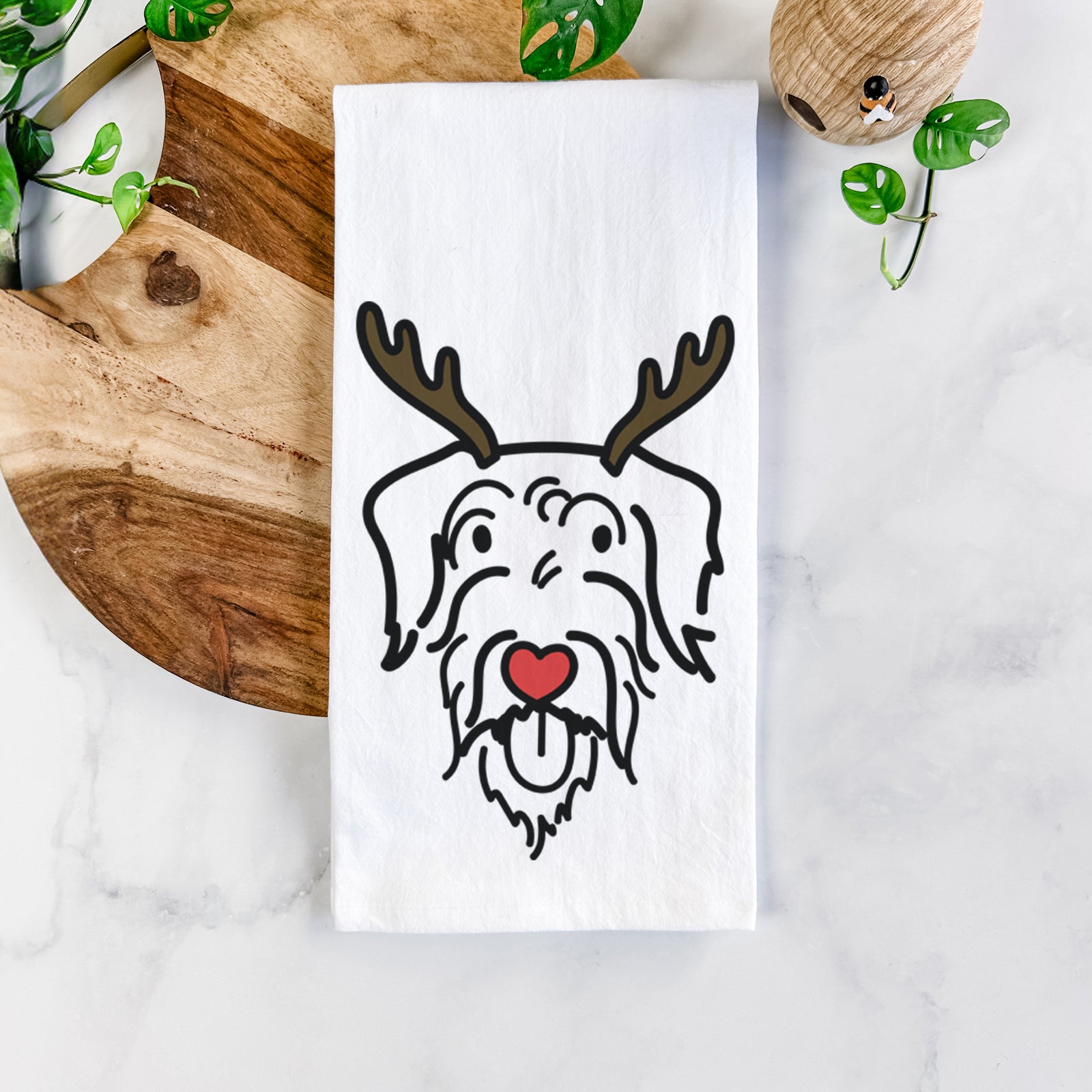Minimalist line drawing of Dug the Doodle with reindeer antlers and a red nose on a tea towel