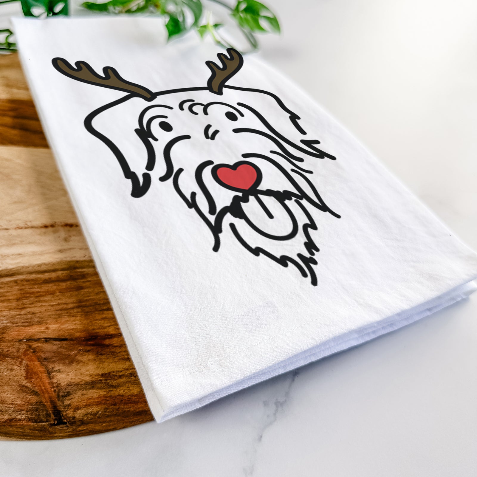 Minimalist line drawing of Dug the Doodle with reindeer antlers and a red nose on a tea towel