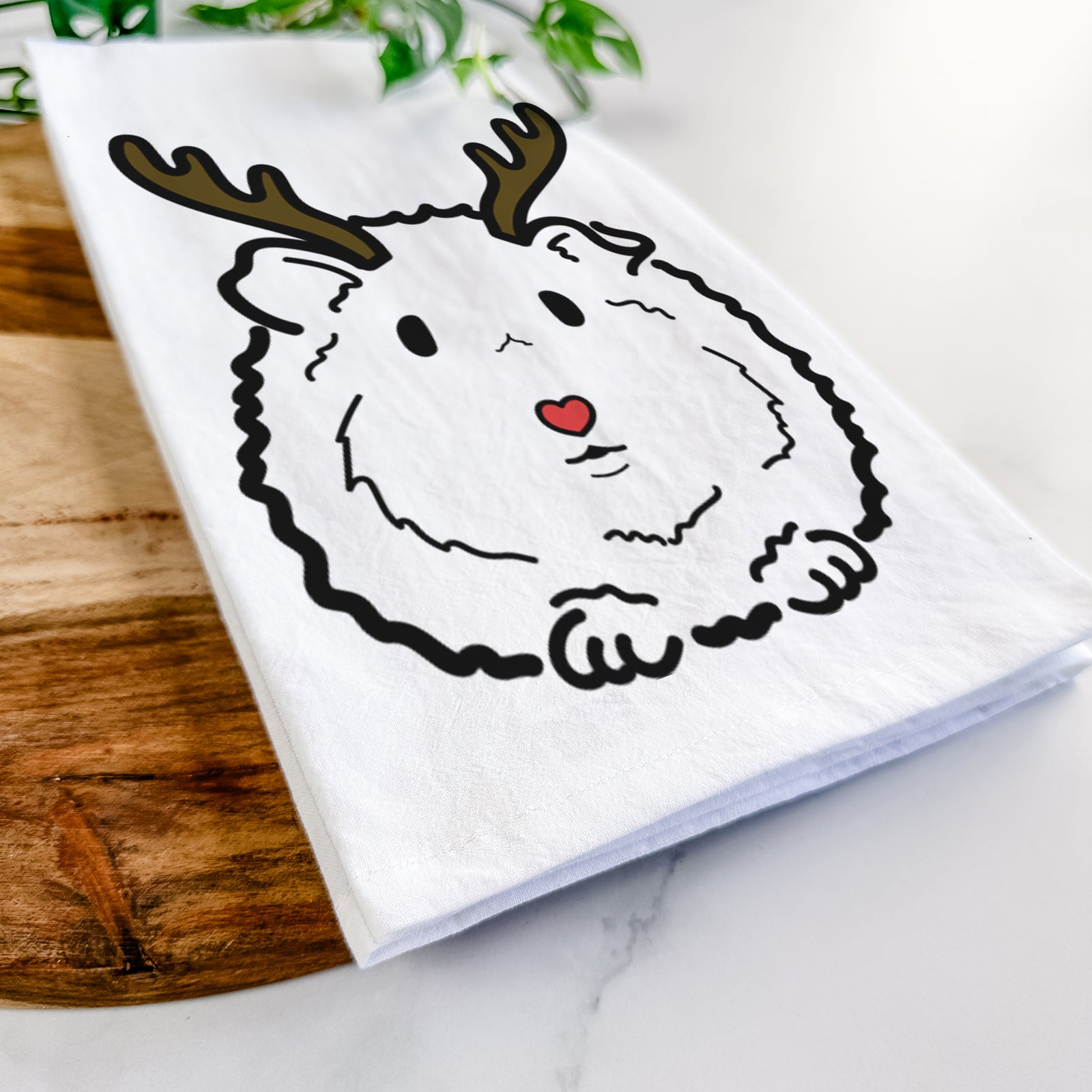 Minimalist line drawing of Duke the Guinea Pig with reindeer antlers and a red nose on a tea towel
