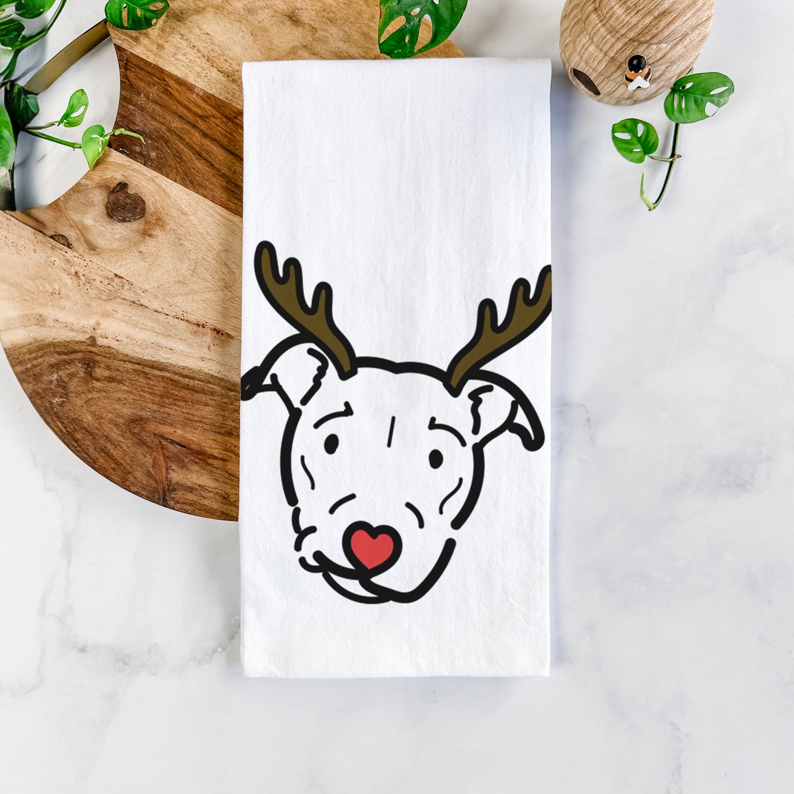 Minimalist line drawing of Ernie the Pitbull Mix with reindeer antlers and a red nose on a tea towel