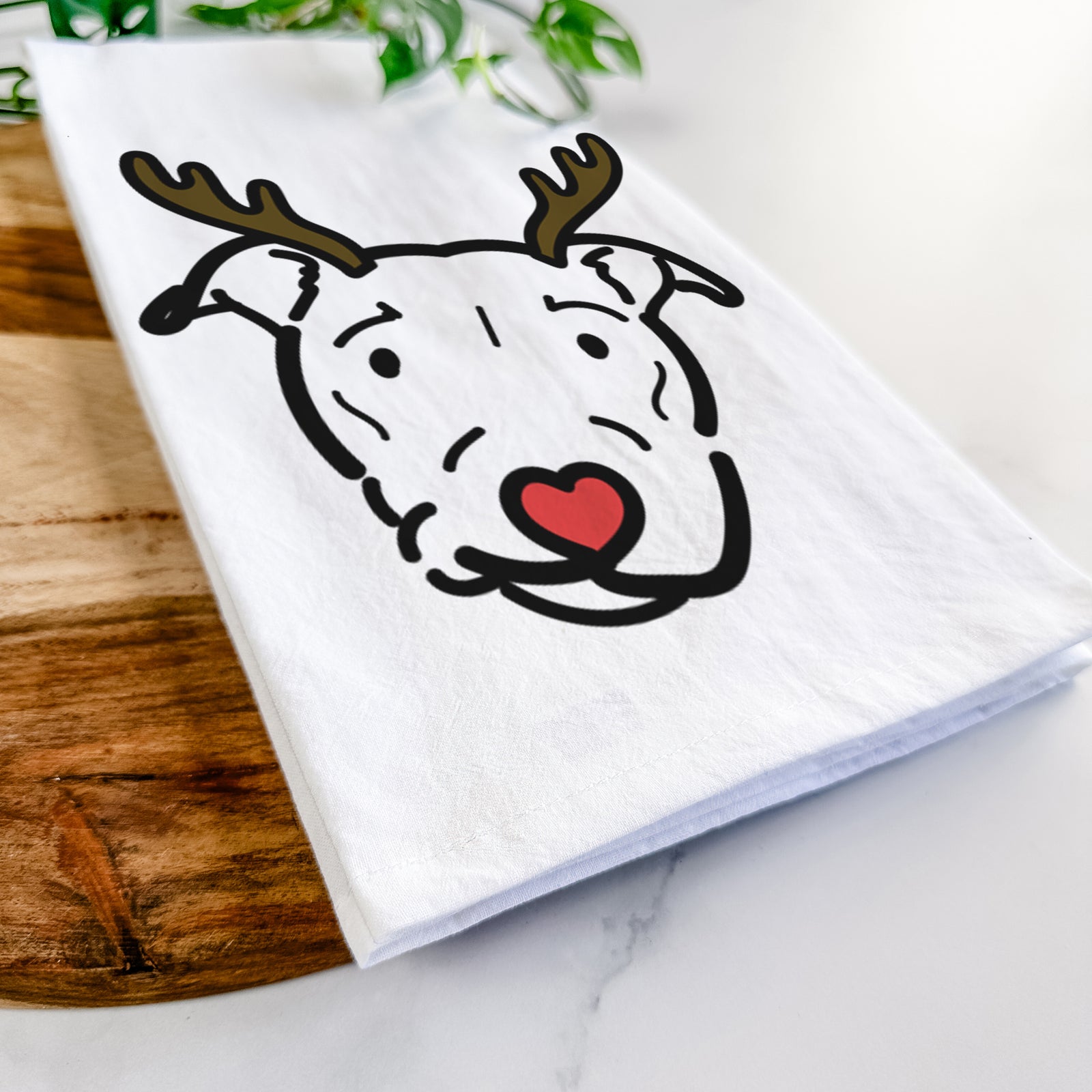 Minimalist line drawing of Ernie the Pitbull Mix with reindeer antlers and a red nose on a tea towel