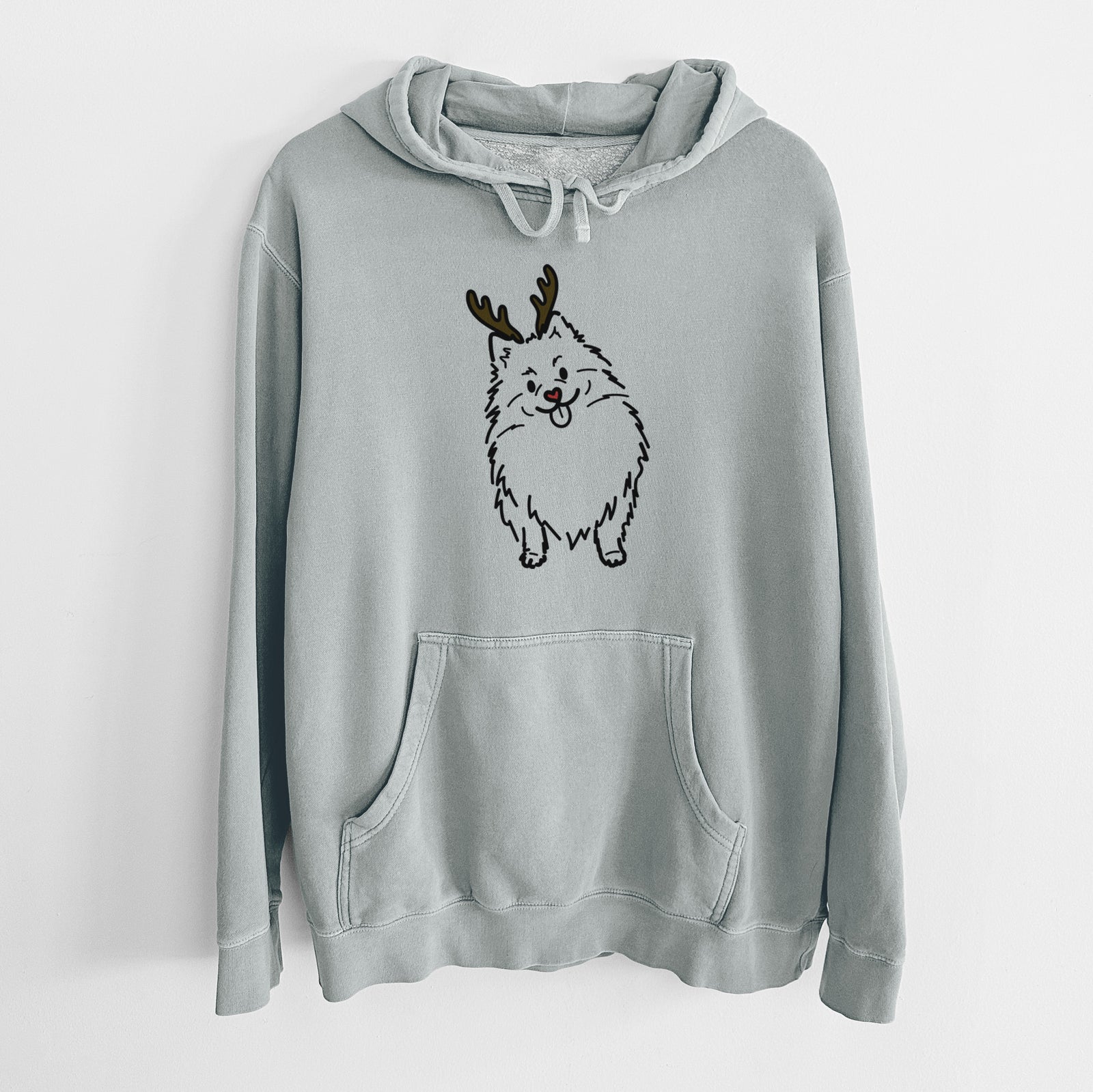 Minimalist line drawing of Fern the Pomeranian with reindeer antlers and a red nose on a Sage Unisex pigment dyed hoodie