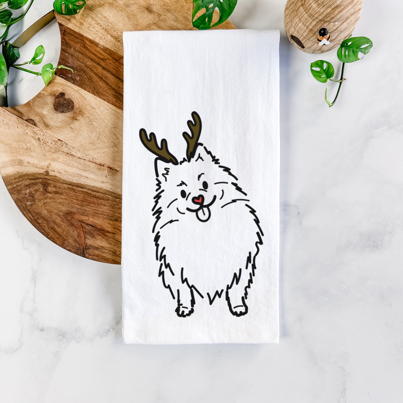 Minimalist line drawing of Fern the Pomeranian with reindeer antlers and a red nose on a tea towel