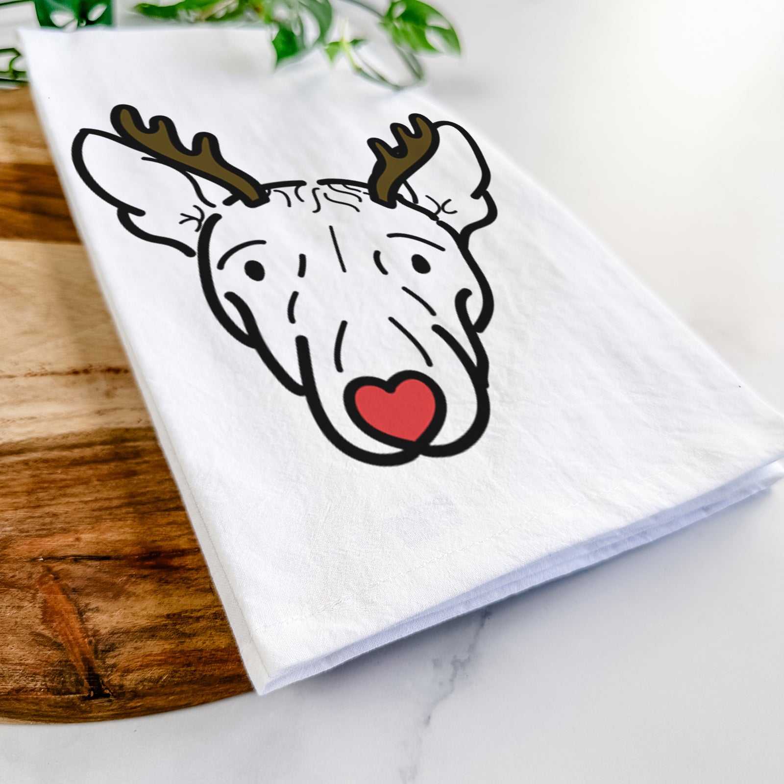 Minimalist line drawing of Georgia the American Hairless Terrier with reindeer antlers and a red nose on a tea towel