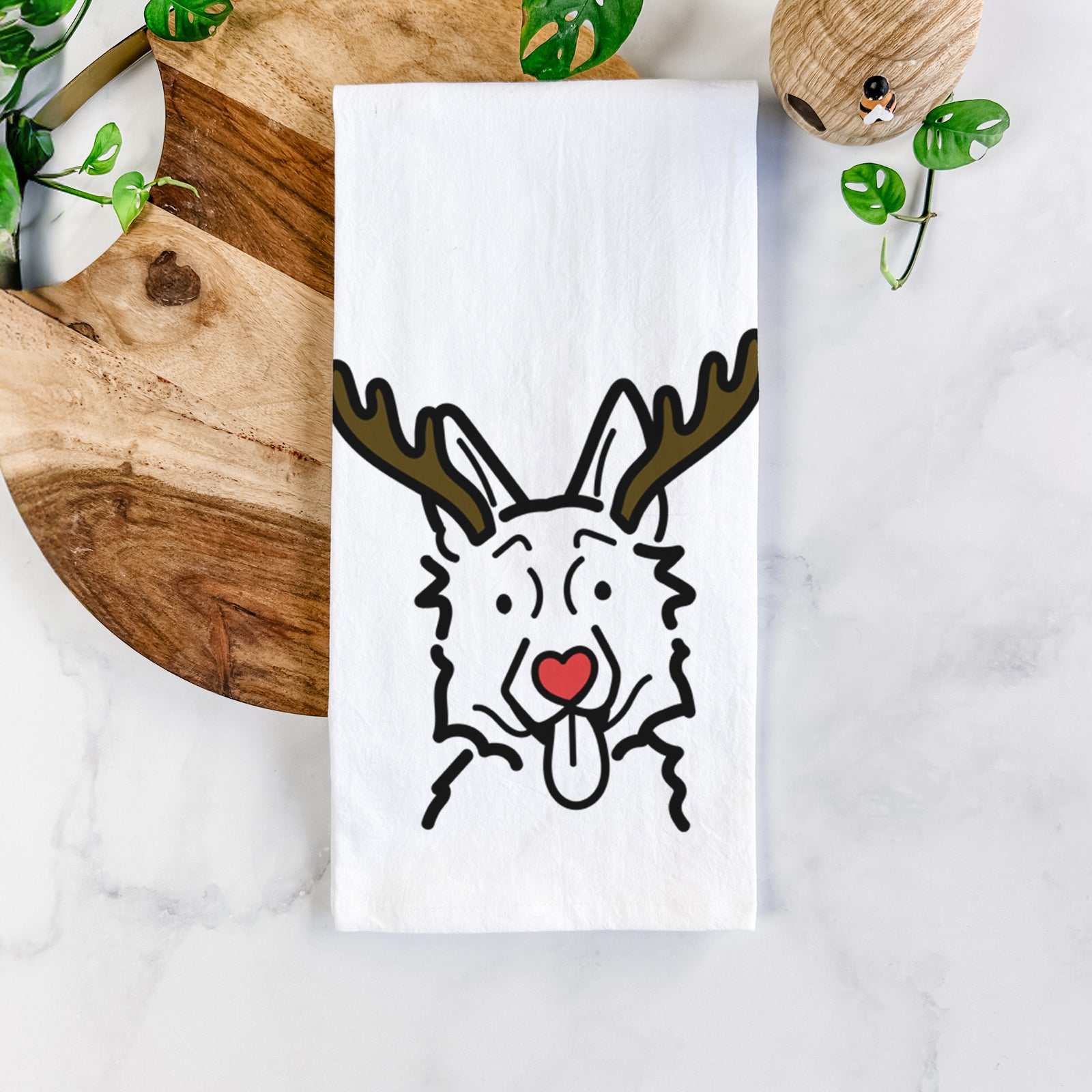 Minimalist line drawing of a German Shepherd with reindeer antlers and a red nose on a tea towel