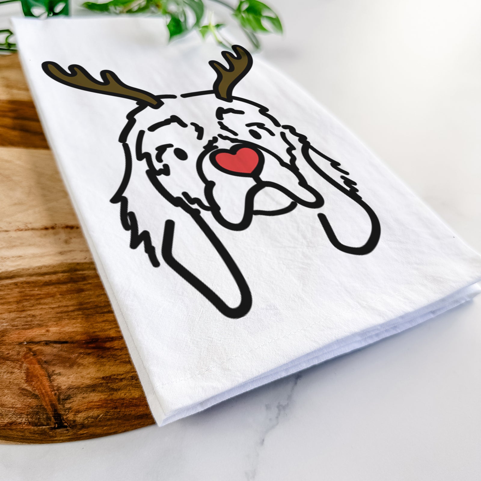 Minimalist line drawing of GiGi the Cocker Spaniel with reindeer antlers and a red nose on a tea towel