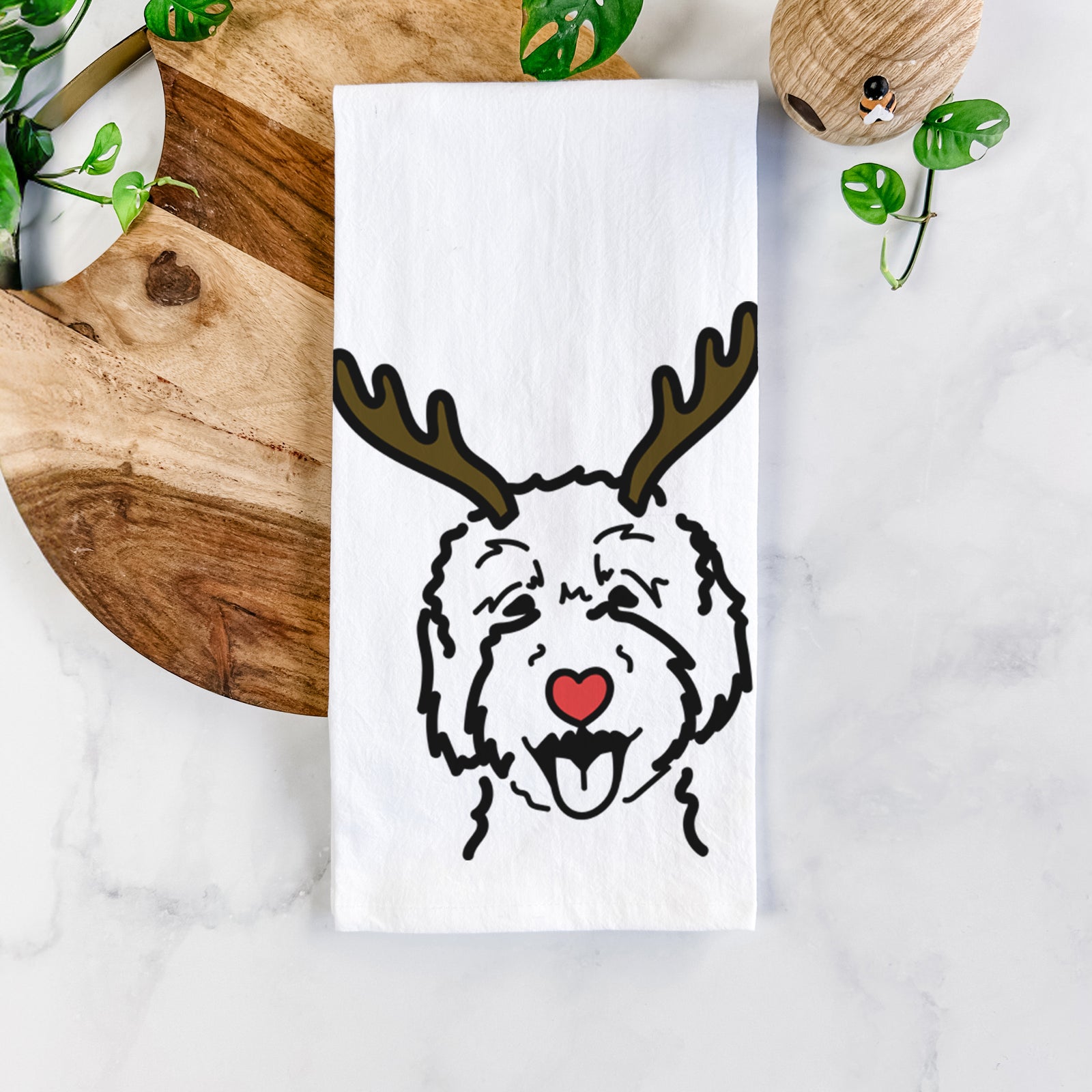 Minimalist line drawing of a Goldendoodle 2 with reindeer antlers and a red nose on a tea towel