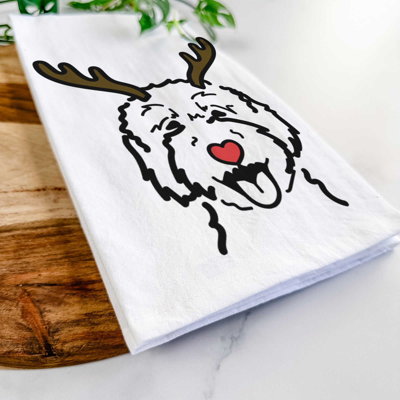 Minimalist line drawing of a Goldendoodle 2 with reindeer antlers and a red nose on a tea towel