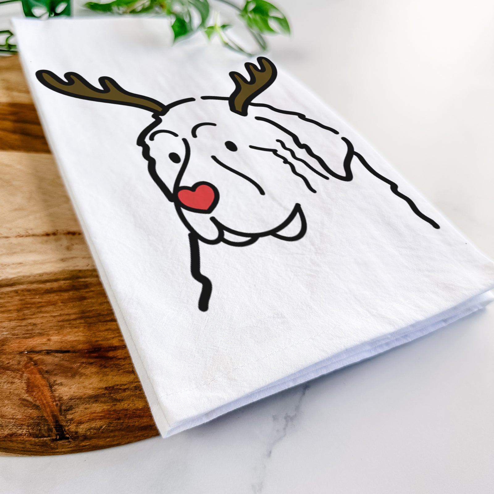 Minimalist line drawing of a Great Pyrenees with reindeer antlers and a red nose on a tea towel