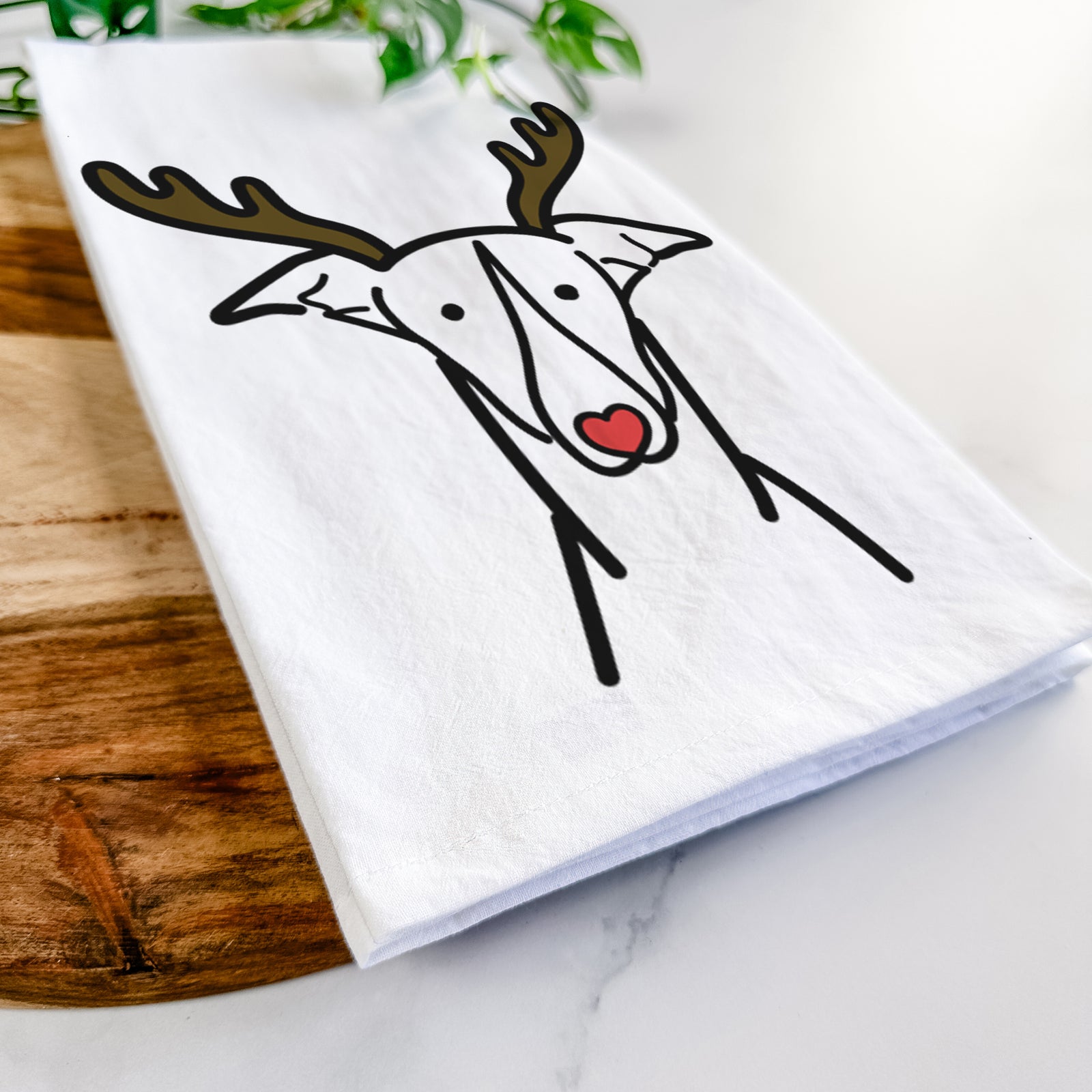 Minimalist line drawing of a Greyhound with reindeer antlers and a red nose on a tea towel