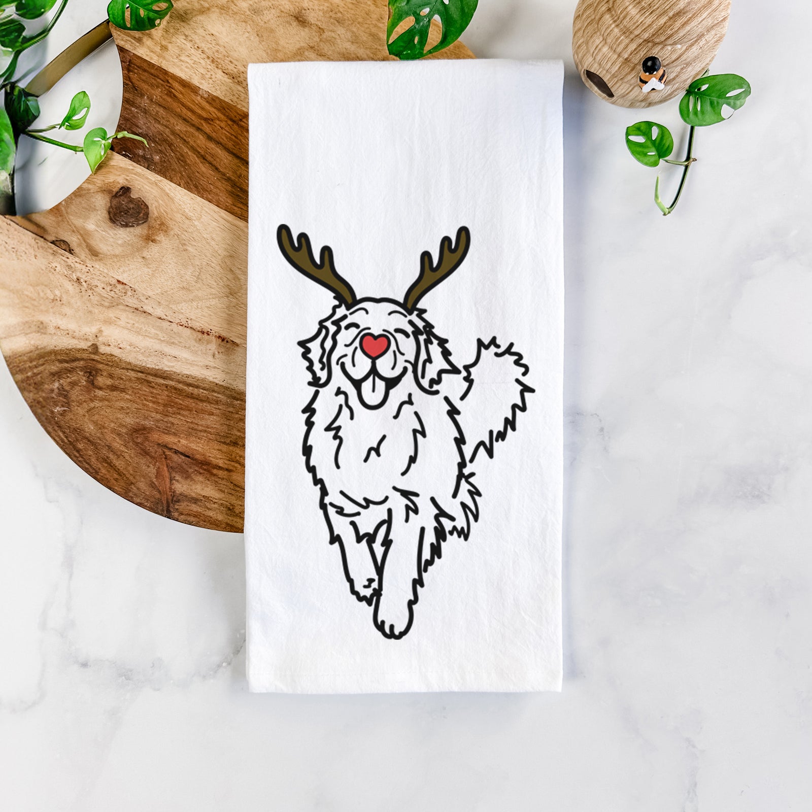 Minimalist line drawing of Hamlet the Golden Retriever with reindeer antlers and a red nose on a tea towel