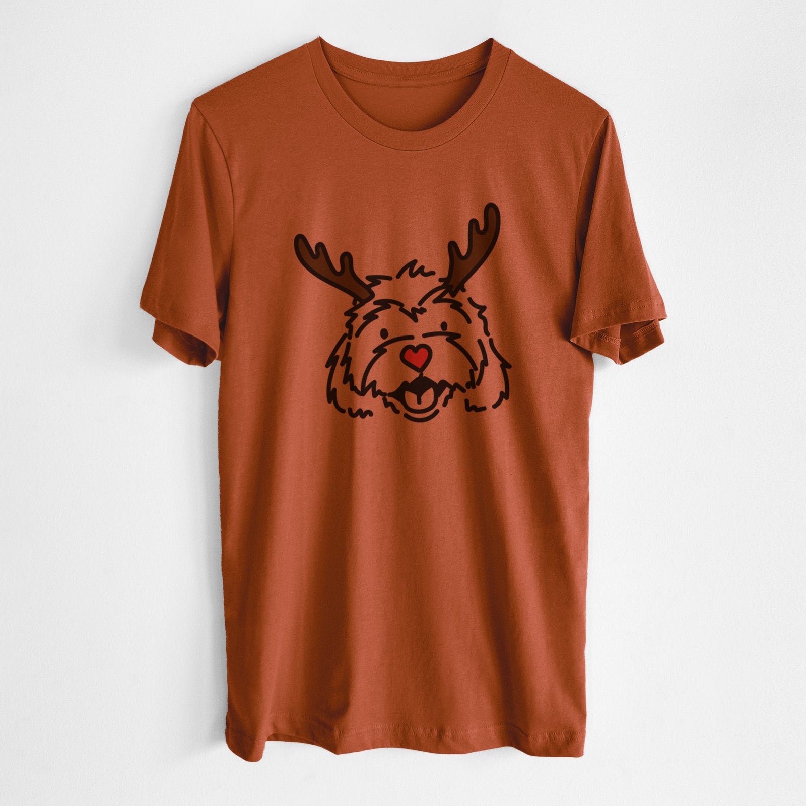 Minimalist line drawing of Harry the Cavachon with reindeer antlers and a red nose on an Autumn Unisex crewneck, worn by a man