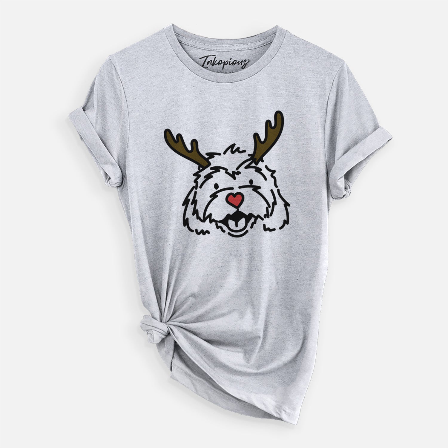 Minimalist line drawing of Harry the Cavachon with reindeer antlers and a red nose on a Grey Unisex crewneck, worn by a woman