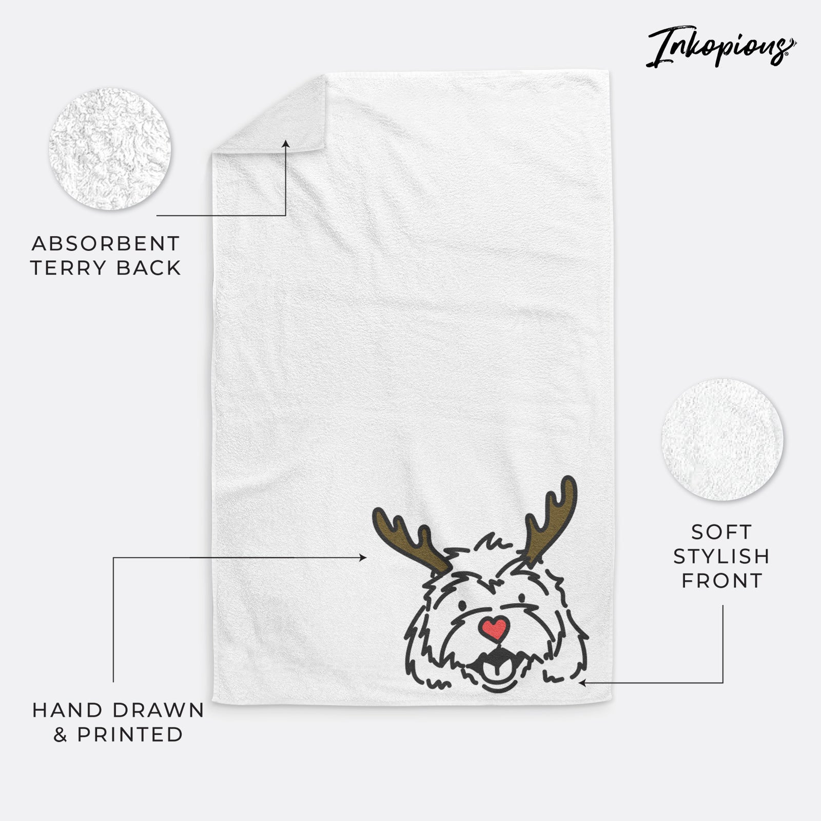 Minimalist line drawing of Harry the Cavachon with reindeer antlers and a red nose on a hand towel