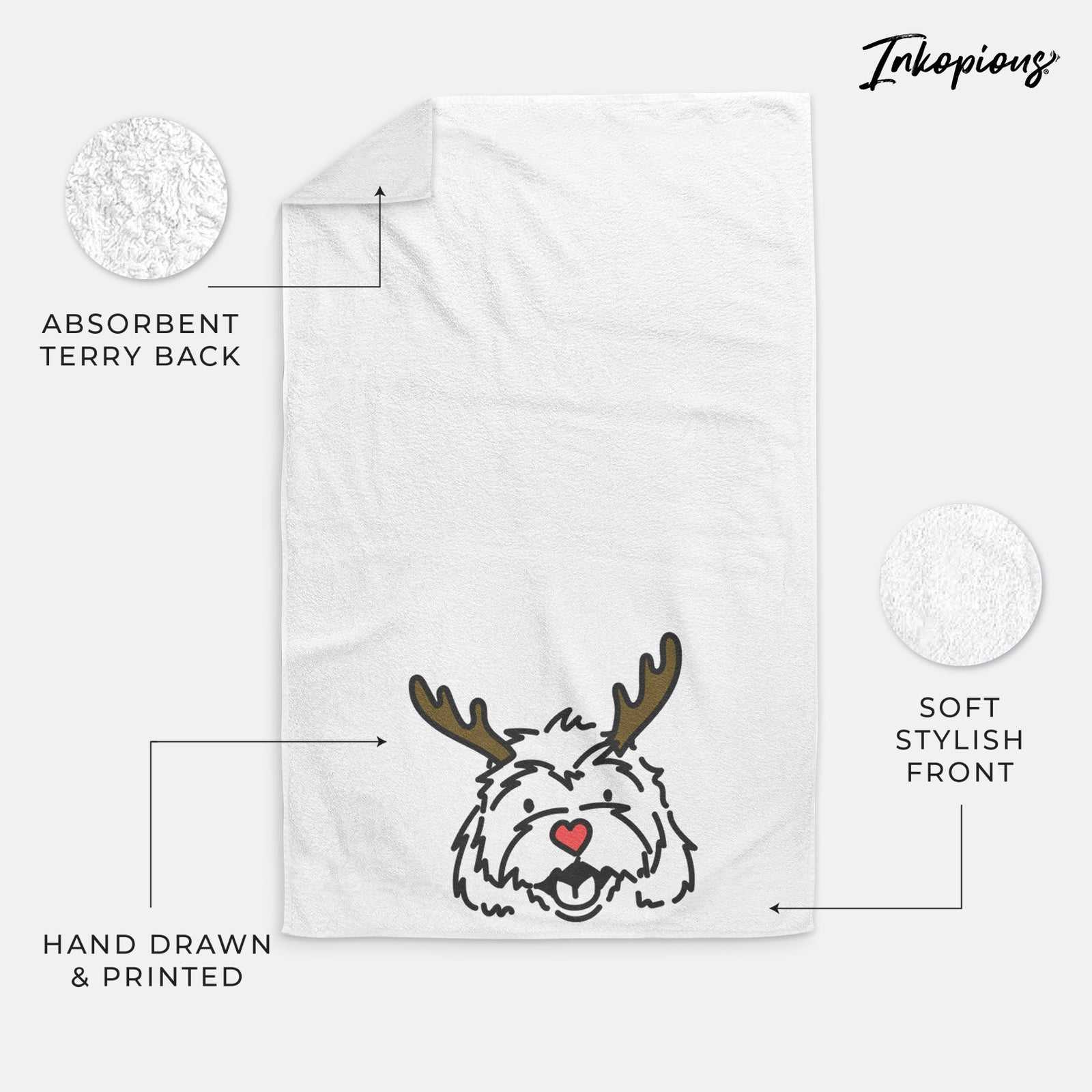 Minimalist line drawing of Harry the Cavachon with reindeer antlers and a red nose on a hand towel