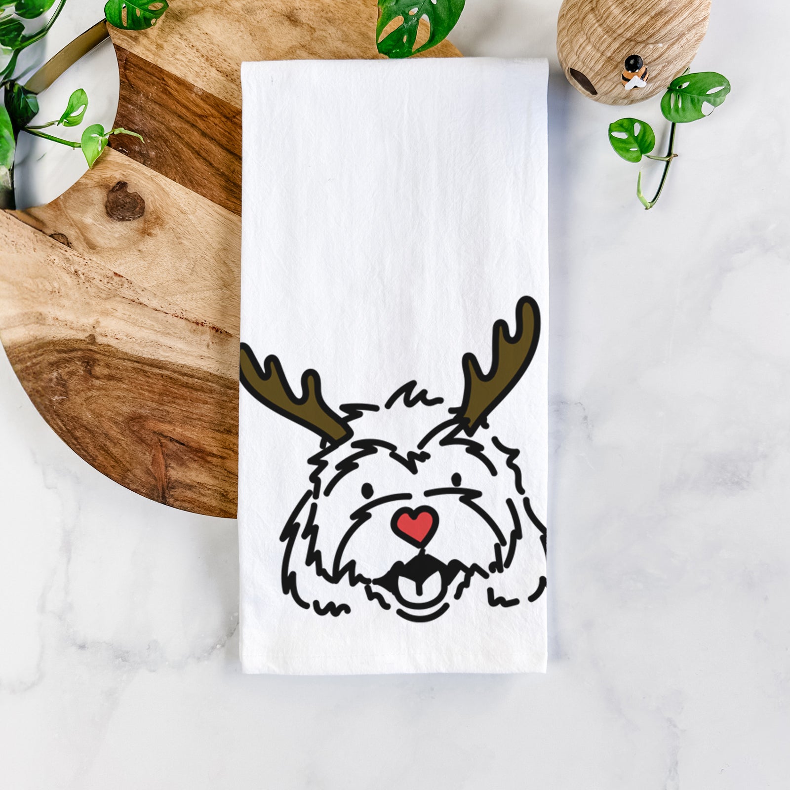 Minimalist line drawing of Harry the Cavachon with reindeer antlers and a red nose on a tea towel