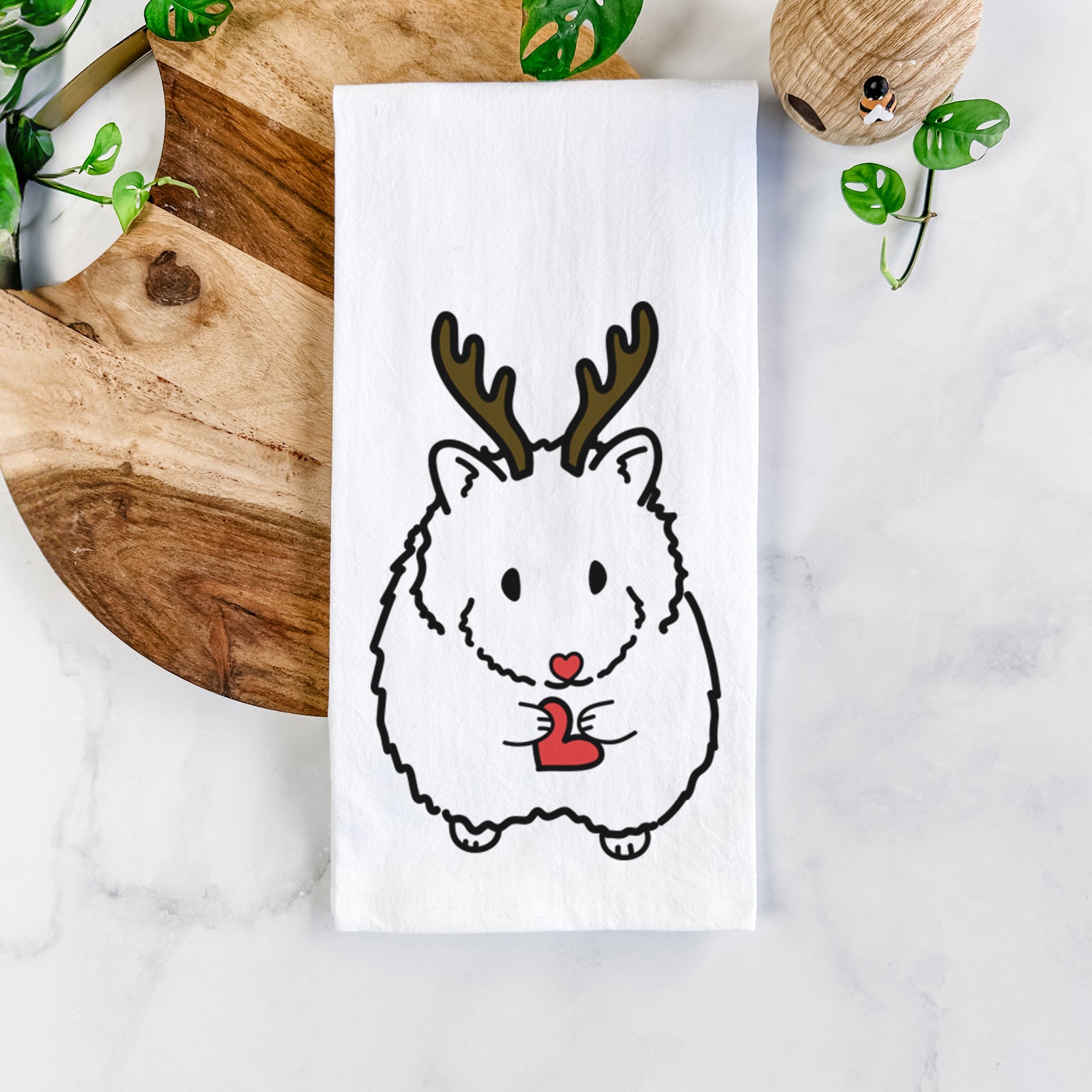 Minimalist line drawing of Hilga the Hamster with reindeer antlers and a red nose on a tea towel