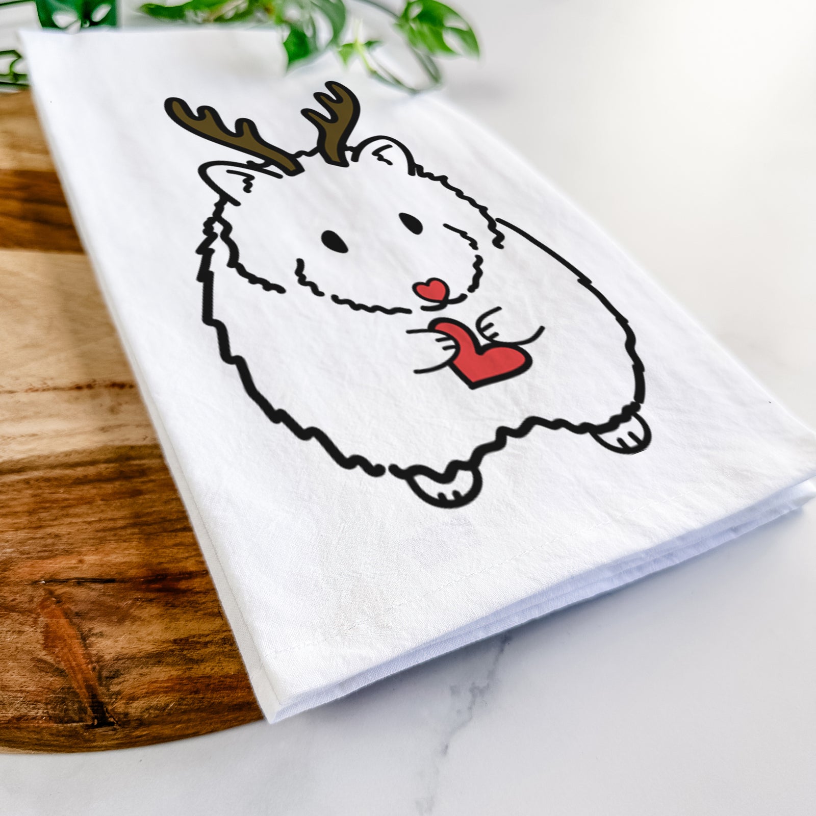 Minimalist line drawing of Hilga the Hamster with reindeer antlers and a red nose on a tea towel