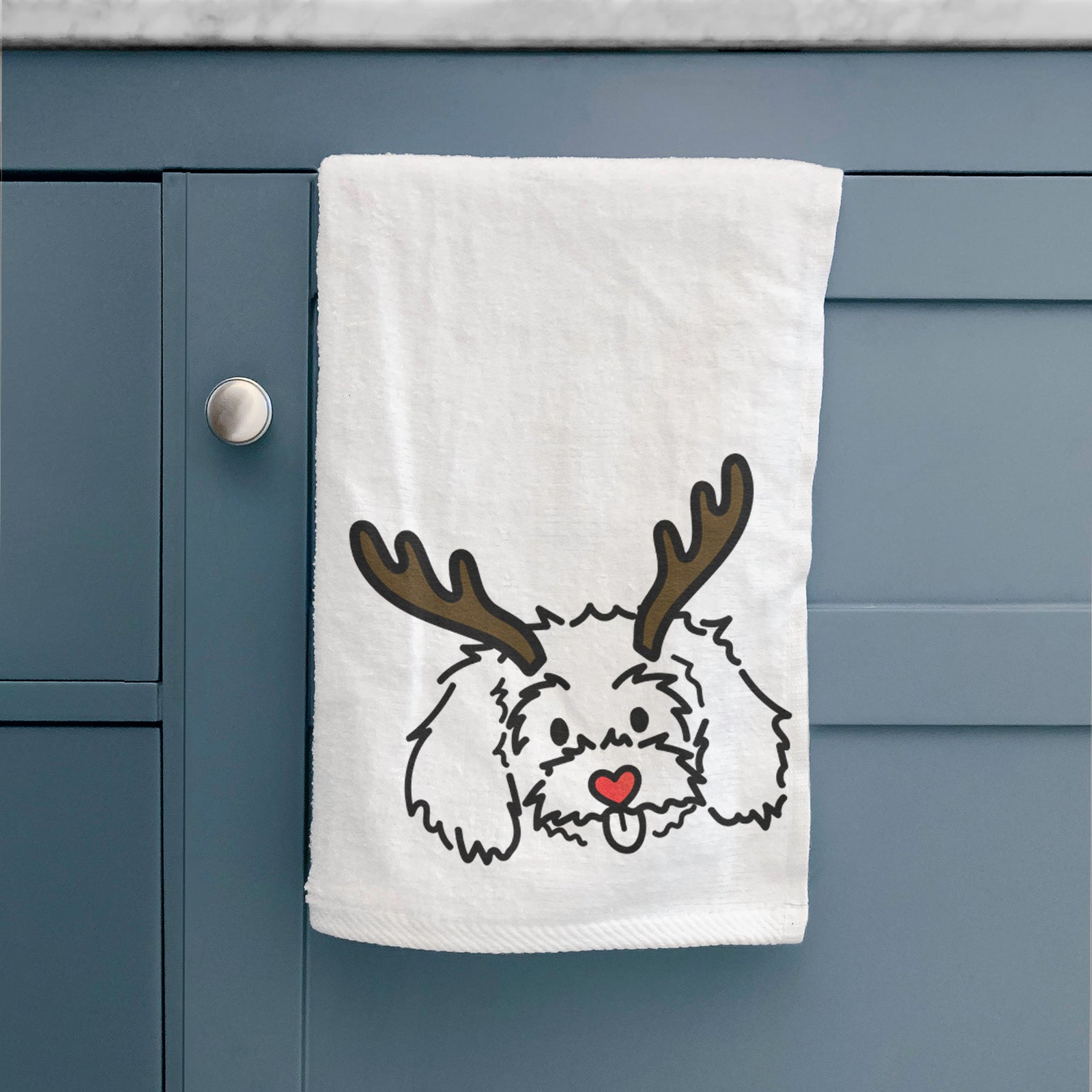 Minimalist line drawing of Holly the Maltipoo with reindeer antlers and a red nose on a decorative hand towel
