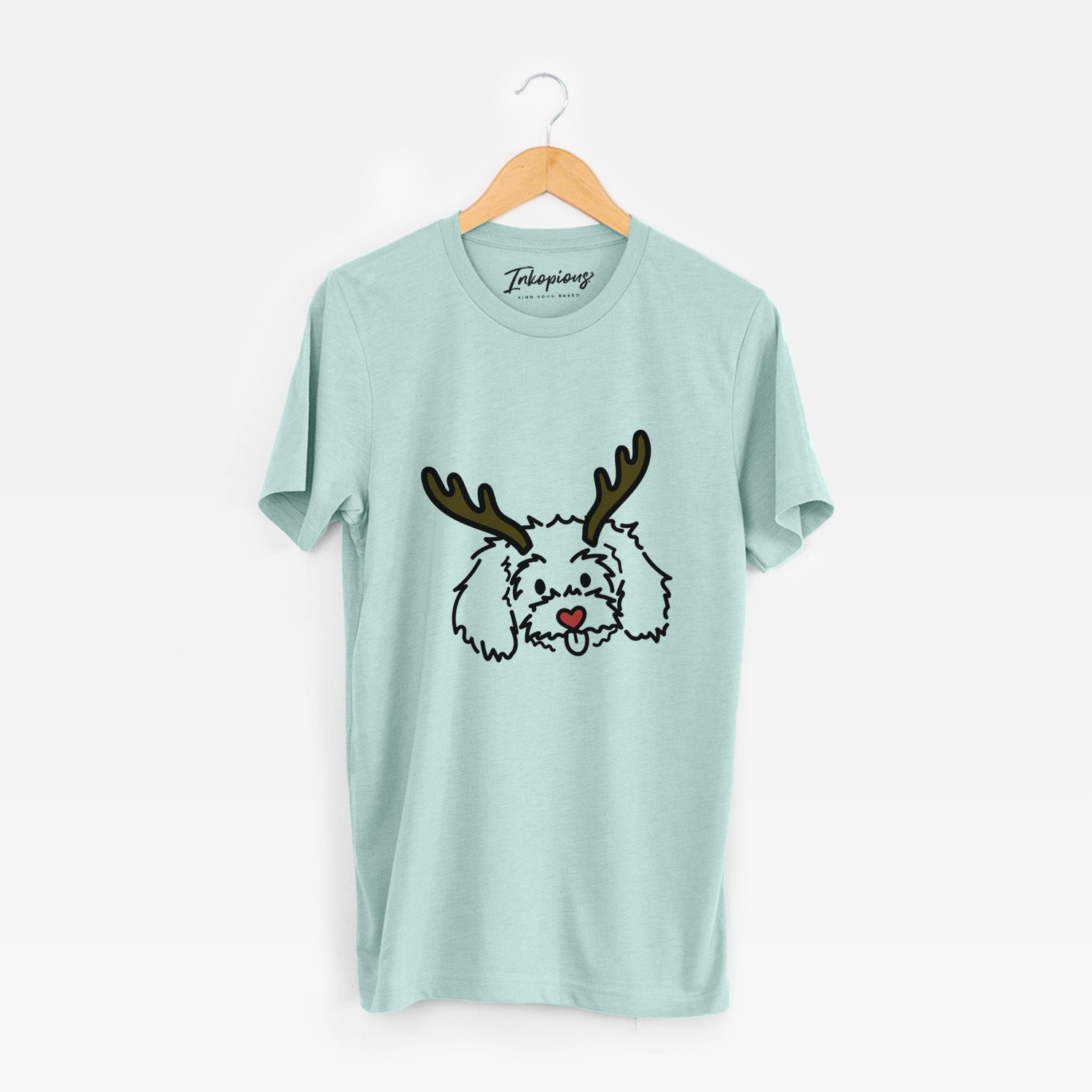 Minimalist line drawing of Holly the Maltipoo with reindeer antlers and a red nose on a Heather Sage Unisex crewneck