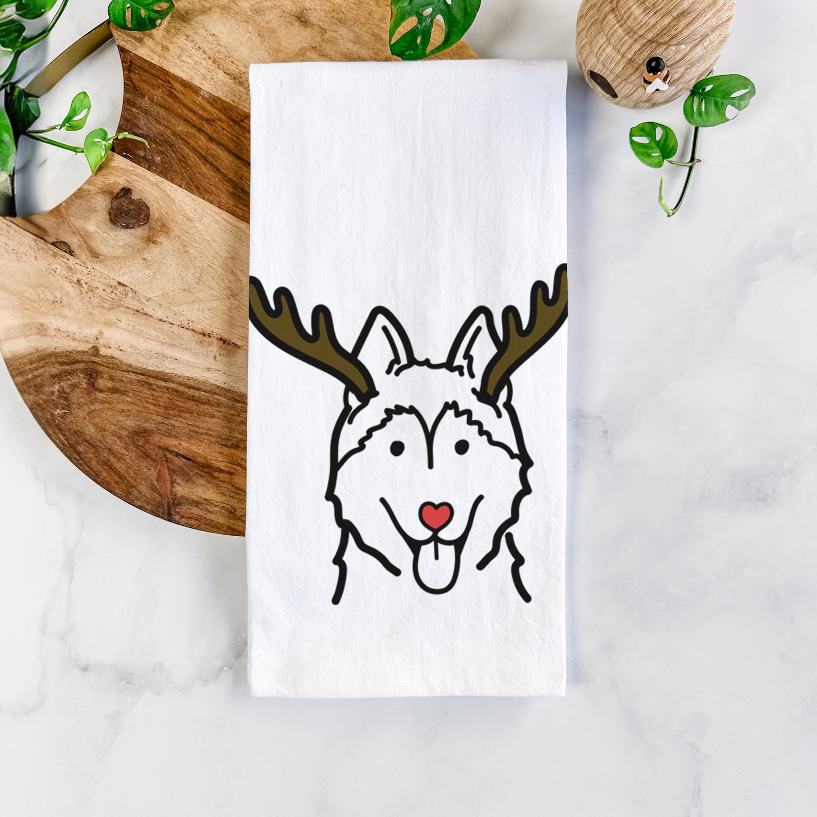 Minimalist line drawing of a Siberian Husky with reindeer antlers and a red nose on a tea towel