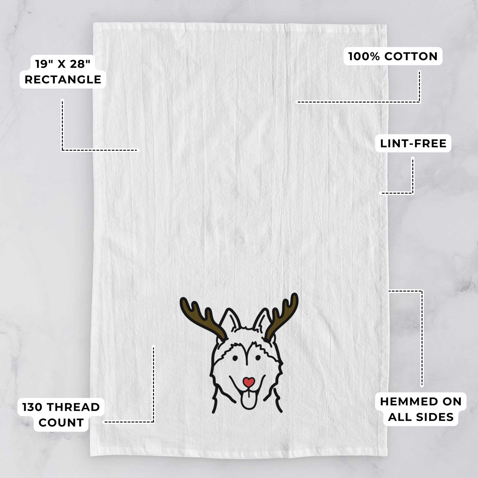 Minimalist line drawing of a Siberian Husky with reindeer antlers and a red nose on a tea towel, with feature callouts: 19 x 28 inch rectangle, 100% cotton, lint-free, 120 thread count, hemmed on all sides