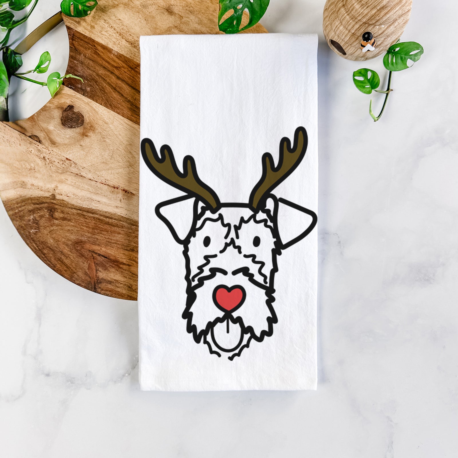 Minimalist line drawing of an Irish Terrier with reindeer antlers and a red nose on a tea towel
