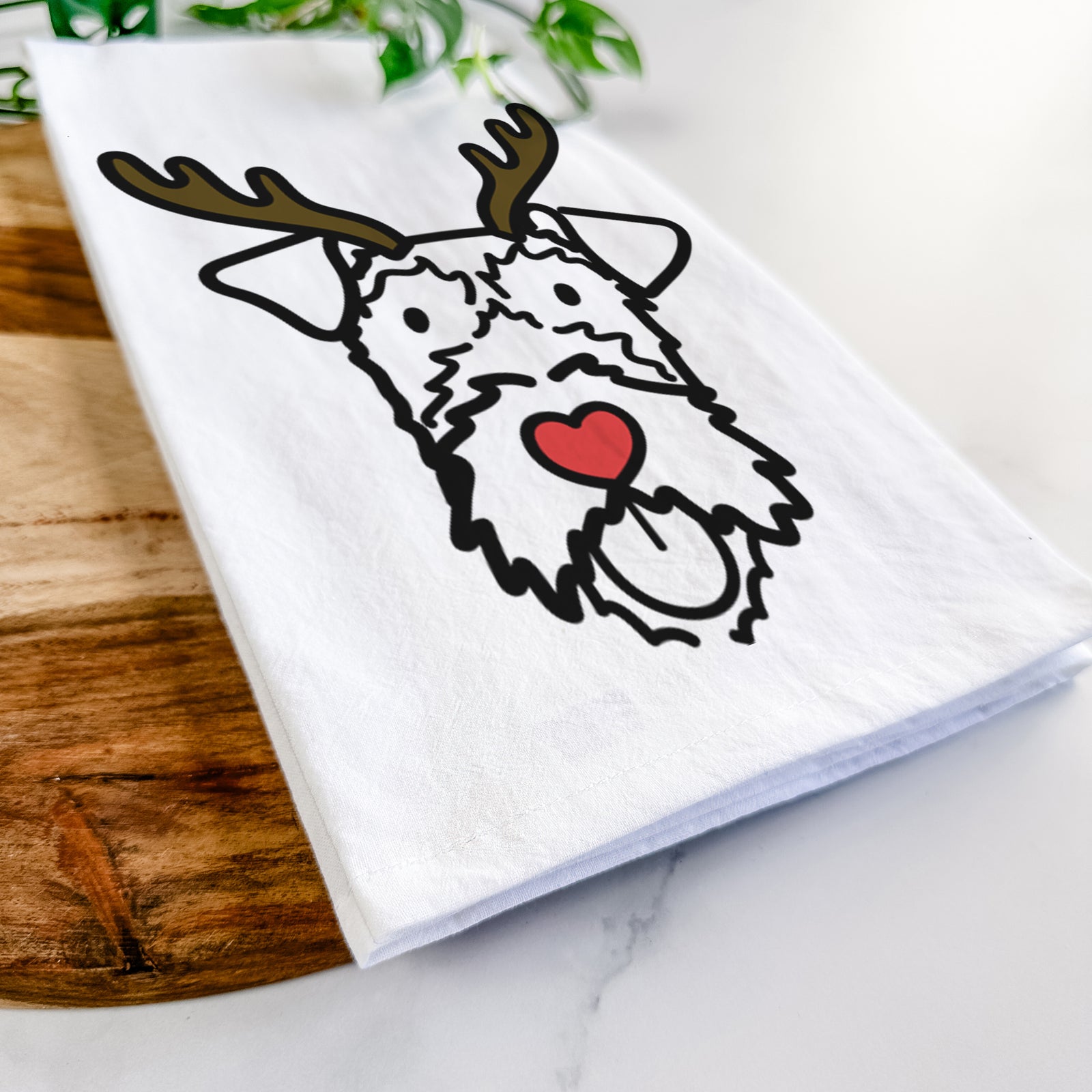 Minimalist line drawing of an Irish Terrier with reindeer antlers and a red nose on a tea towel