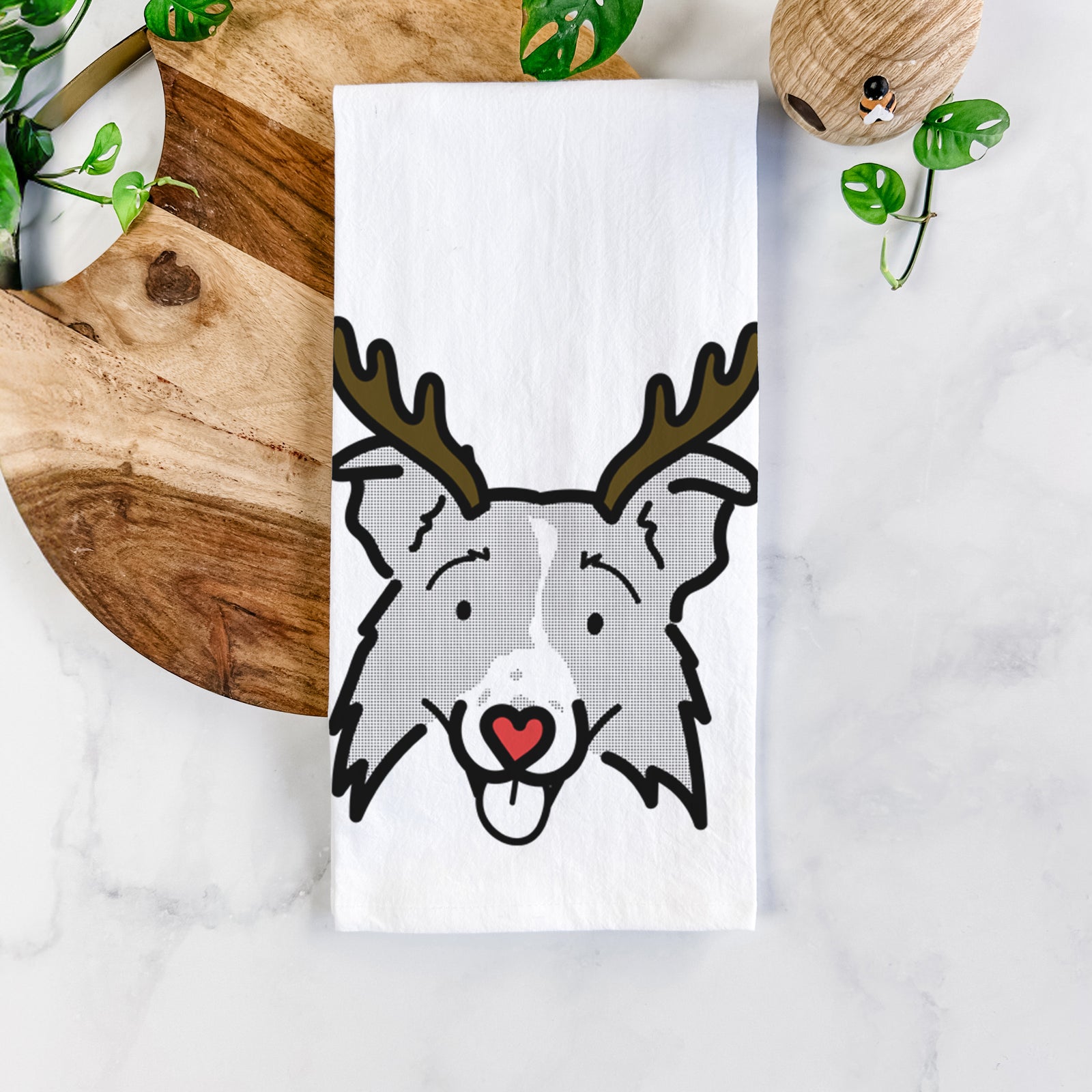 Minimalist line drawing of Jam the Border Collie 2.0 with reindeer antlers and a red nose on a tea towel