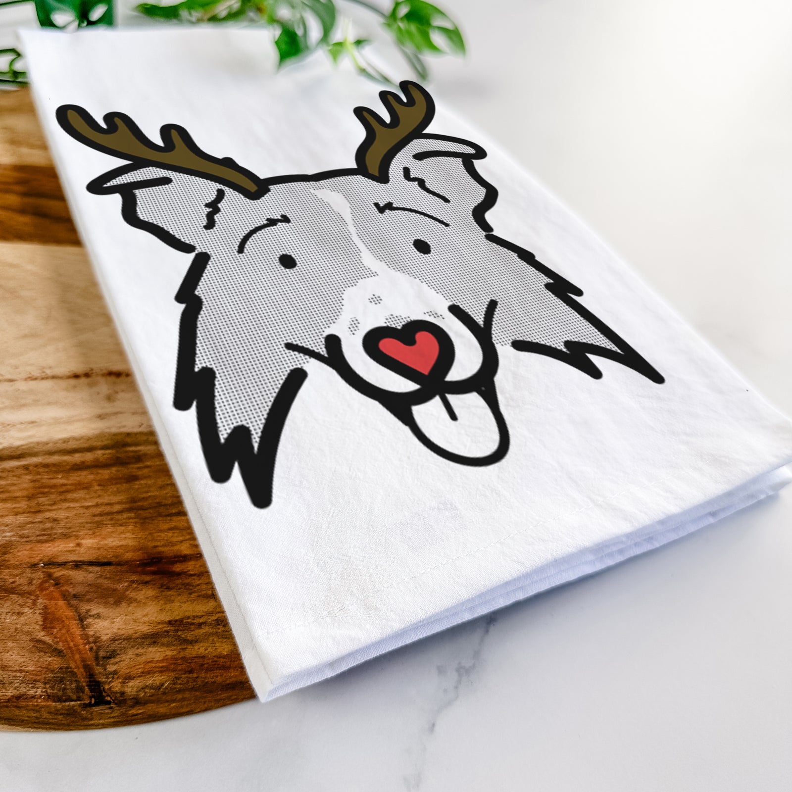 Minimalist line drawing of Jam the Border Collie 2.0 with reindeer antlers and a red nose on a tea towel