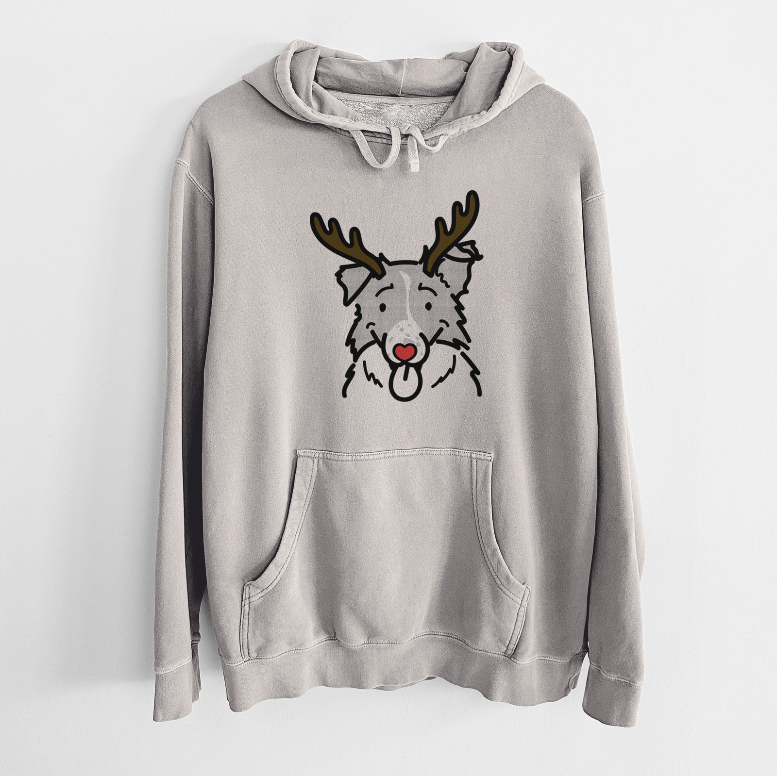 Minimalist line drawing of Jam the Border Collie with reindeer antlers and a red nose on a Cement Unisex pigment dyed hoodie