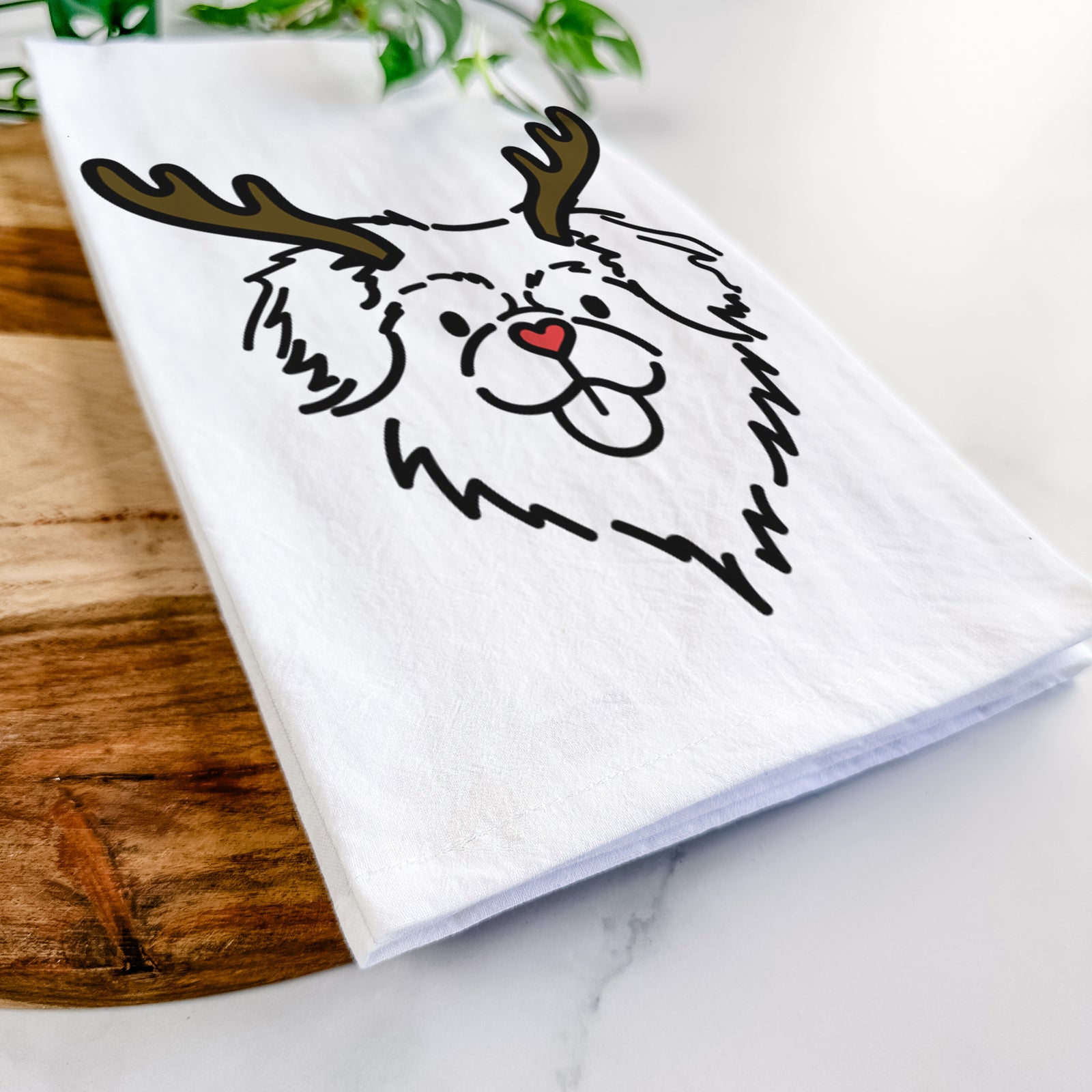 Minimalist line drawing of Jiji the Tibetan Spaniel with reindeer antlers and a red nose on a tea towel