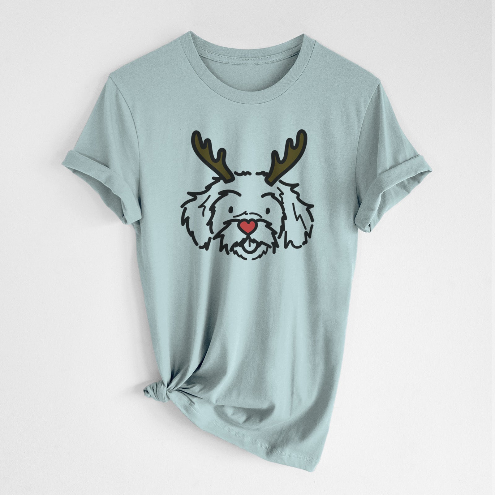 Minimalist line drawing of Jo Jo the Peekapoo with reindeer antlers and a red nose on a Dusty Blue Unisex crewneck, worn by a woman