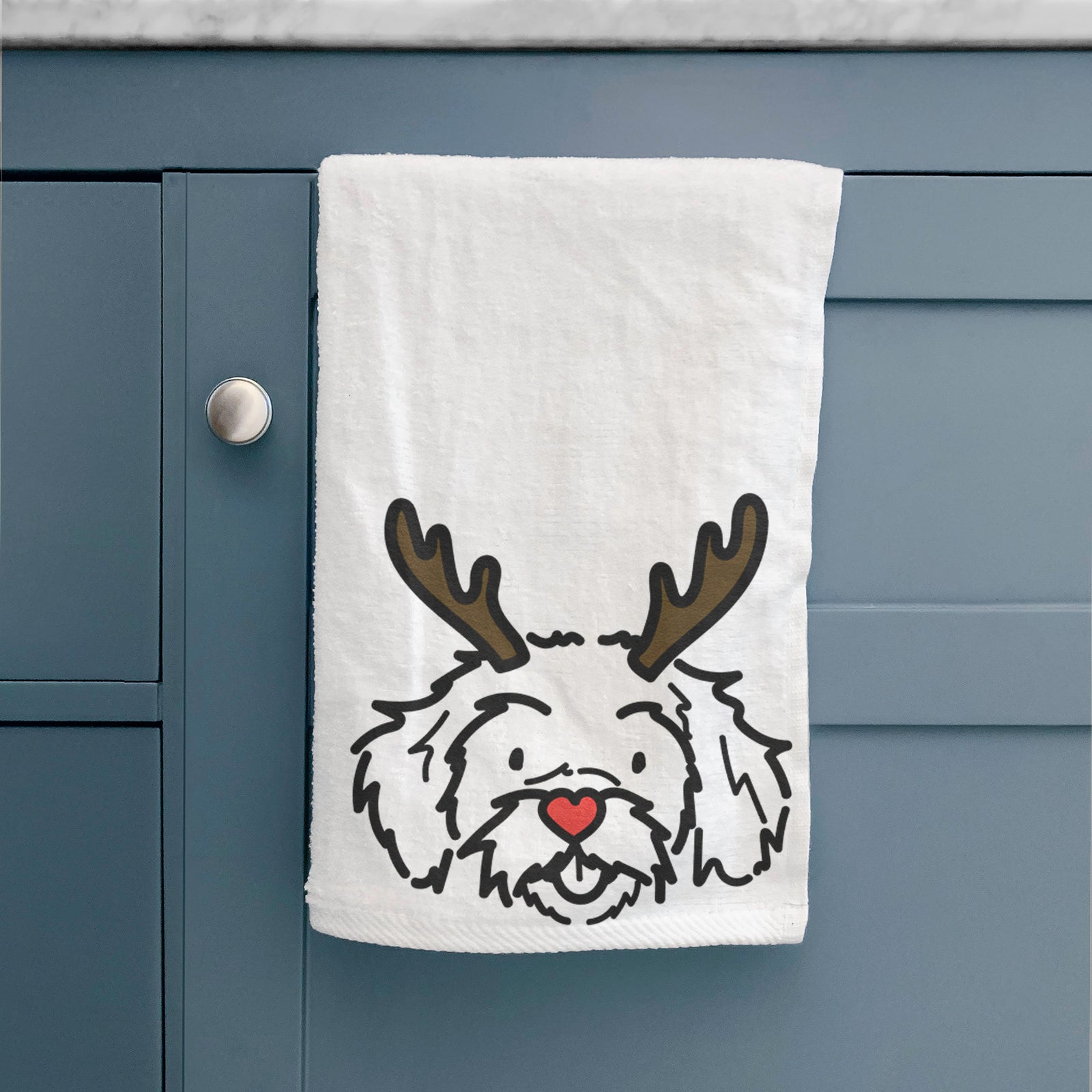 Minimalist line drawing of Jo Jo the Peekapoo with reindeer antlers and a red nose on a hand towel