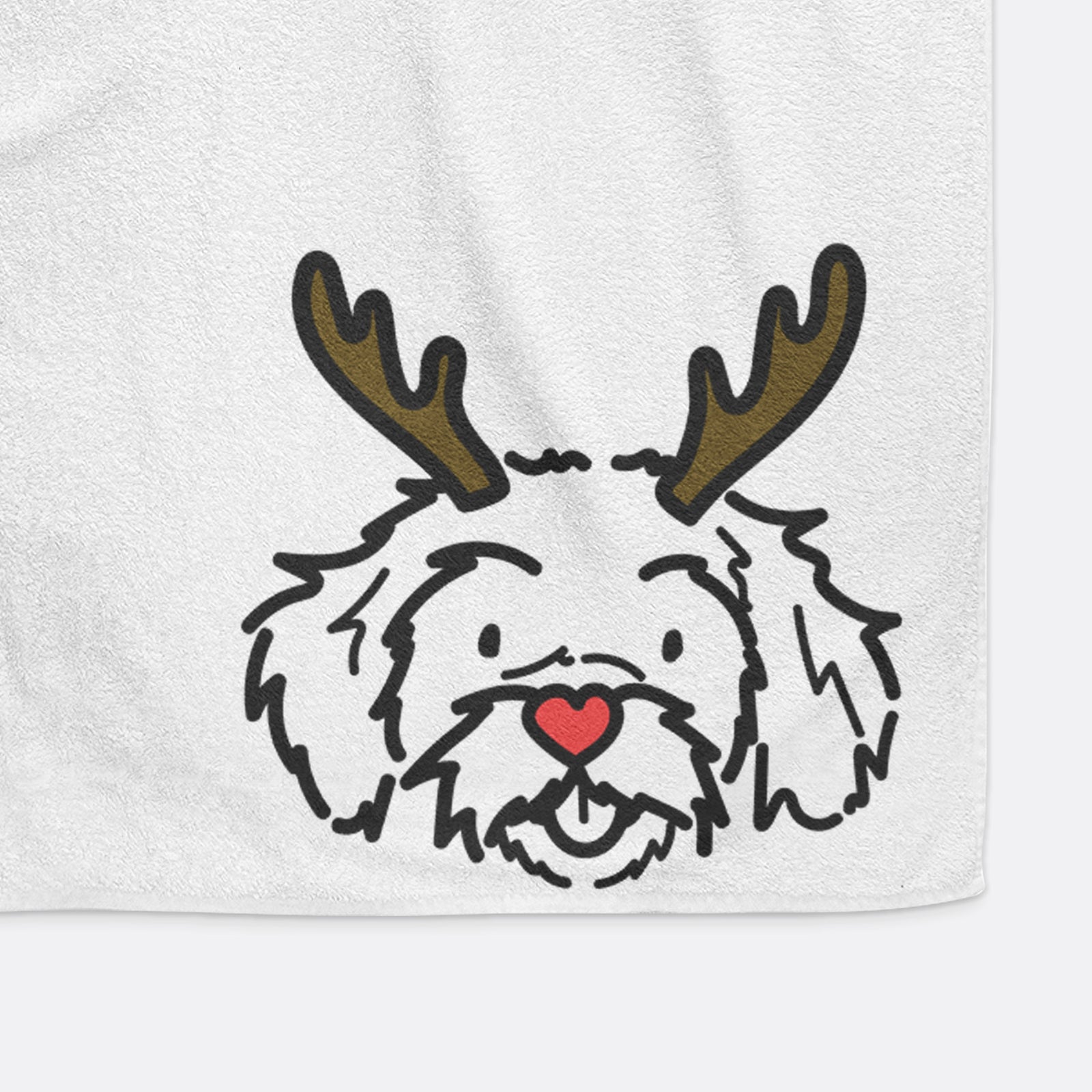 Minimalist line drawing of Jo Jo the Peekapoo with reindeer antlers and a red nose on a hand towel