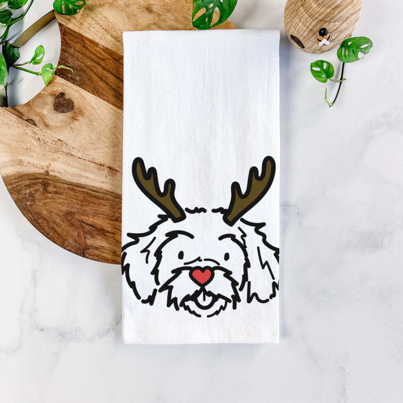 Minimalist line drawing of Jo Jo the Peekapoo with reindeer antlers and a red nose on a tea towel