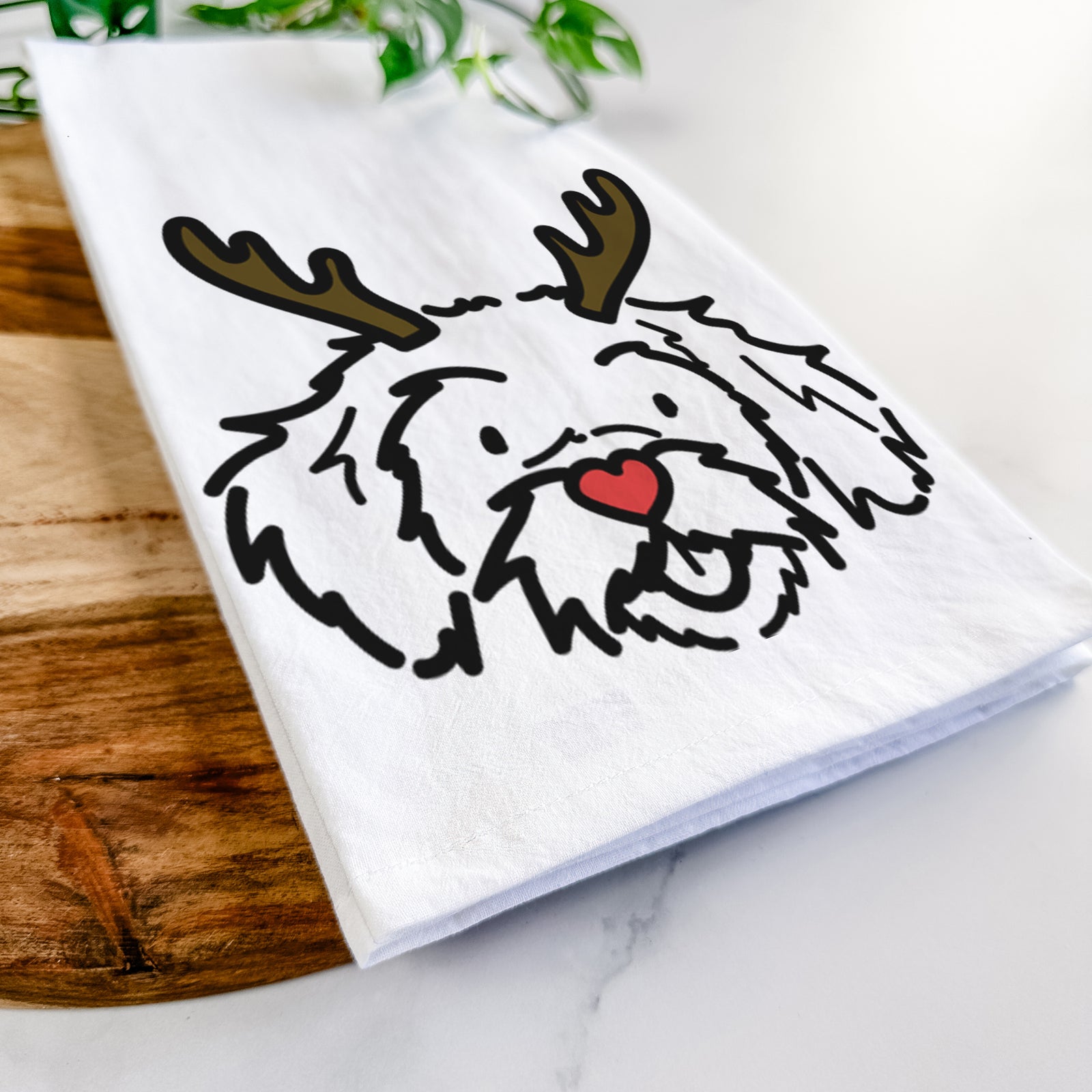 Minimalist line drawing of Jo Jo the Peekapoo with reindeer antlers and a red nose on a tea towel