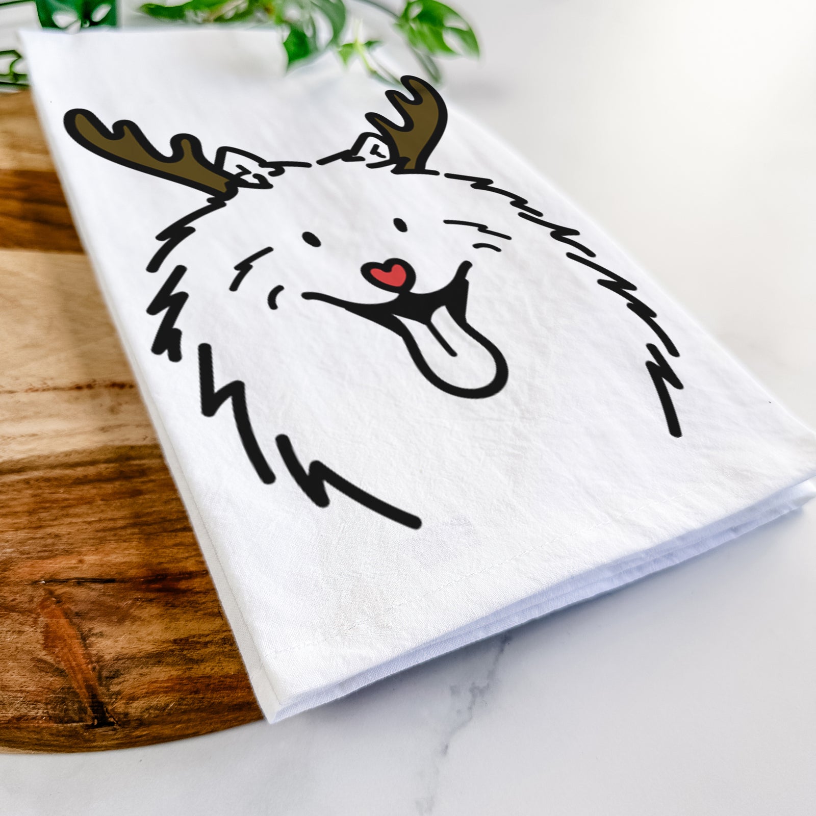 Minimalist line drawing of Johnny the Samoyed with reindeer antlers and a red nose on a tea towel