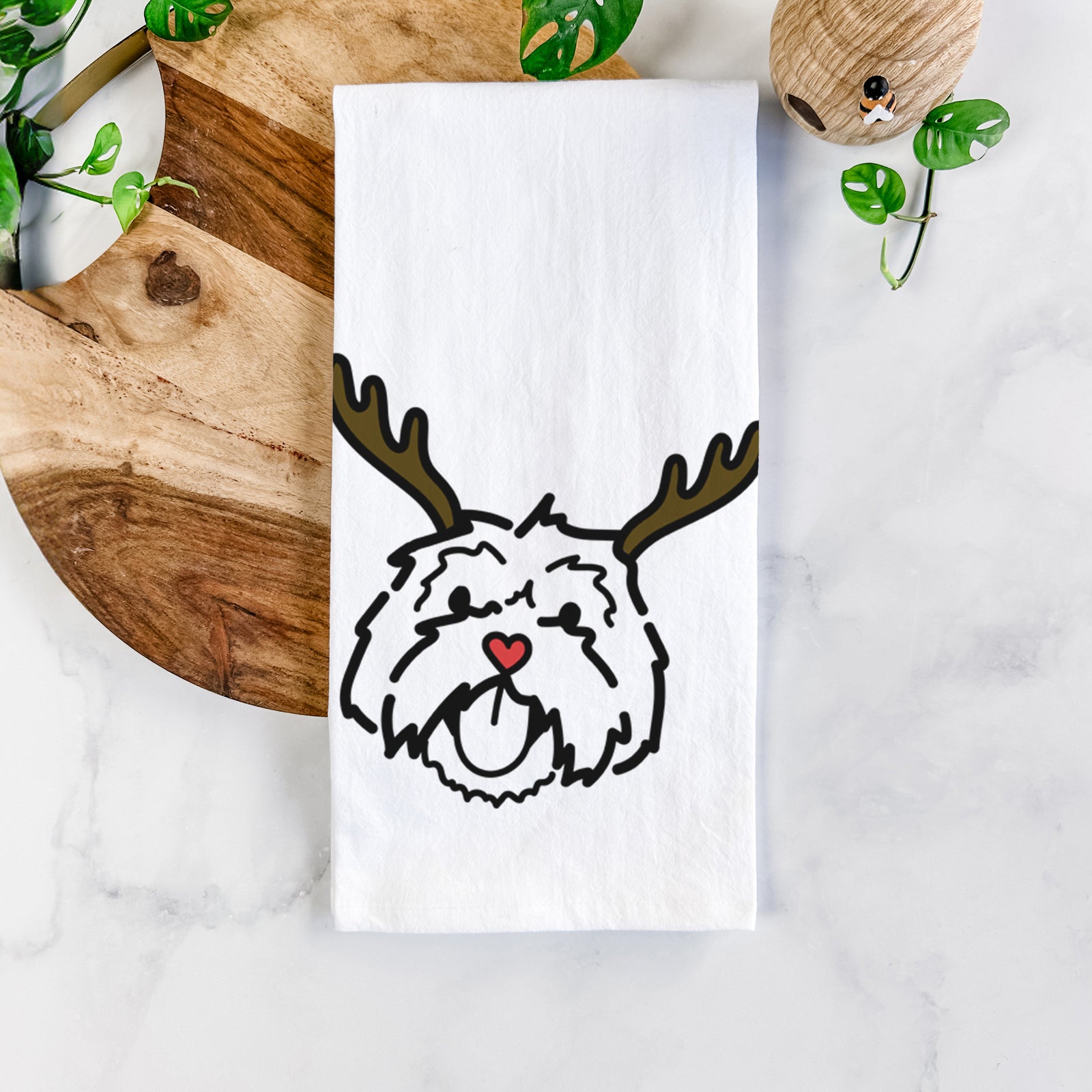 Minimalist line drawing of Keia the Lhasa Apso with reindeer antlers and a red nose on a tea towel