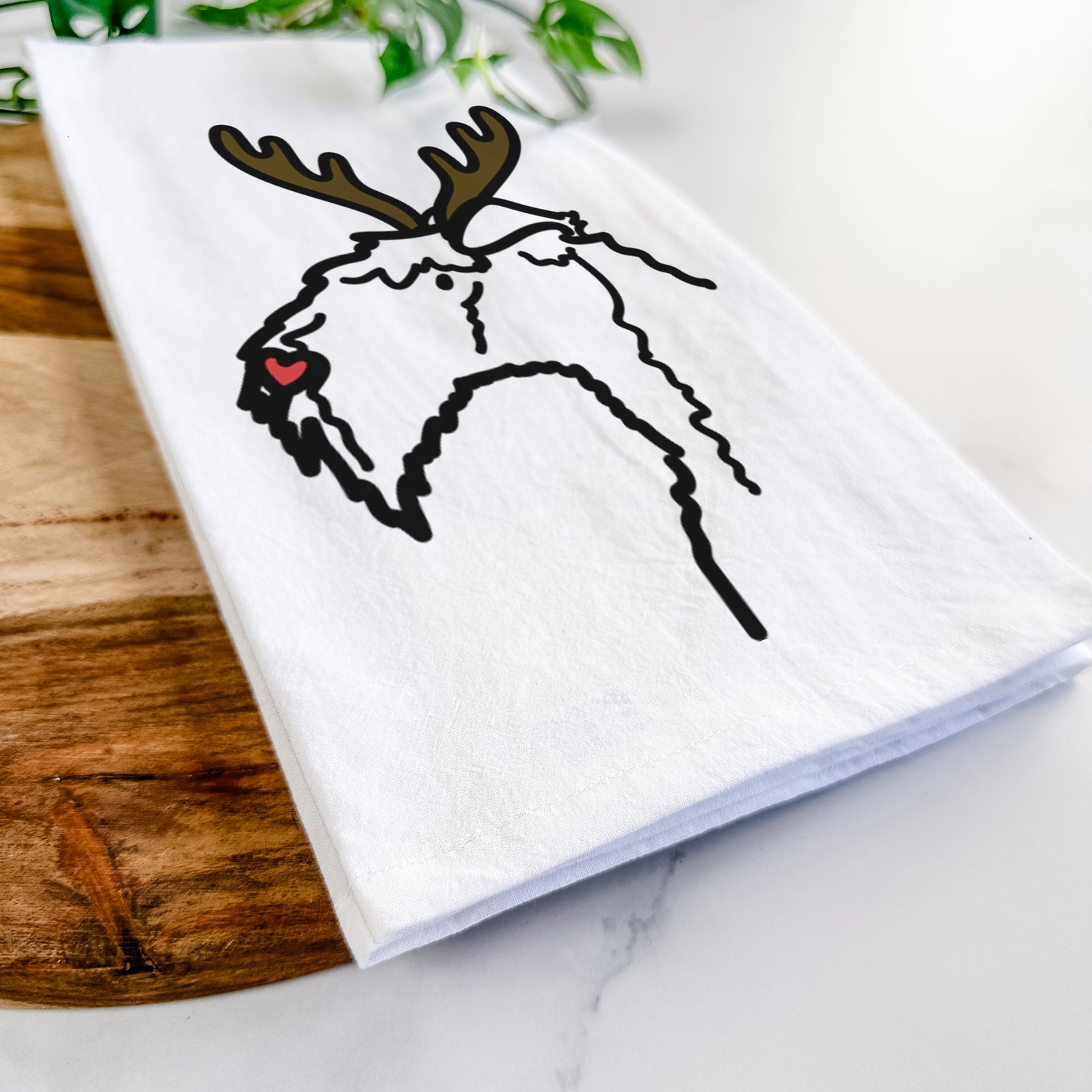 Minimalist line drawing of a Kerry Blue Terrier with reindeer antlers and a red nose on a tea towel