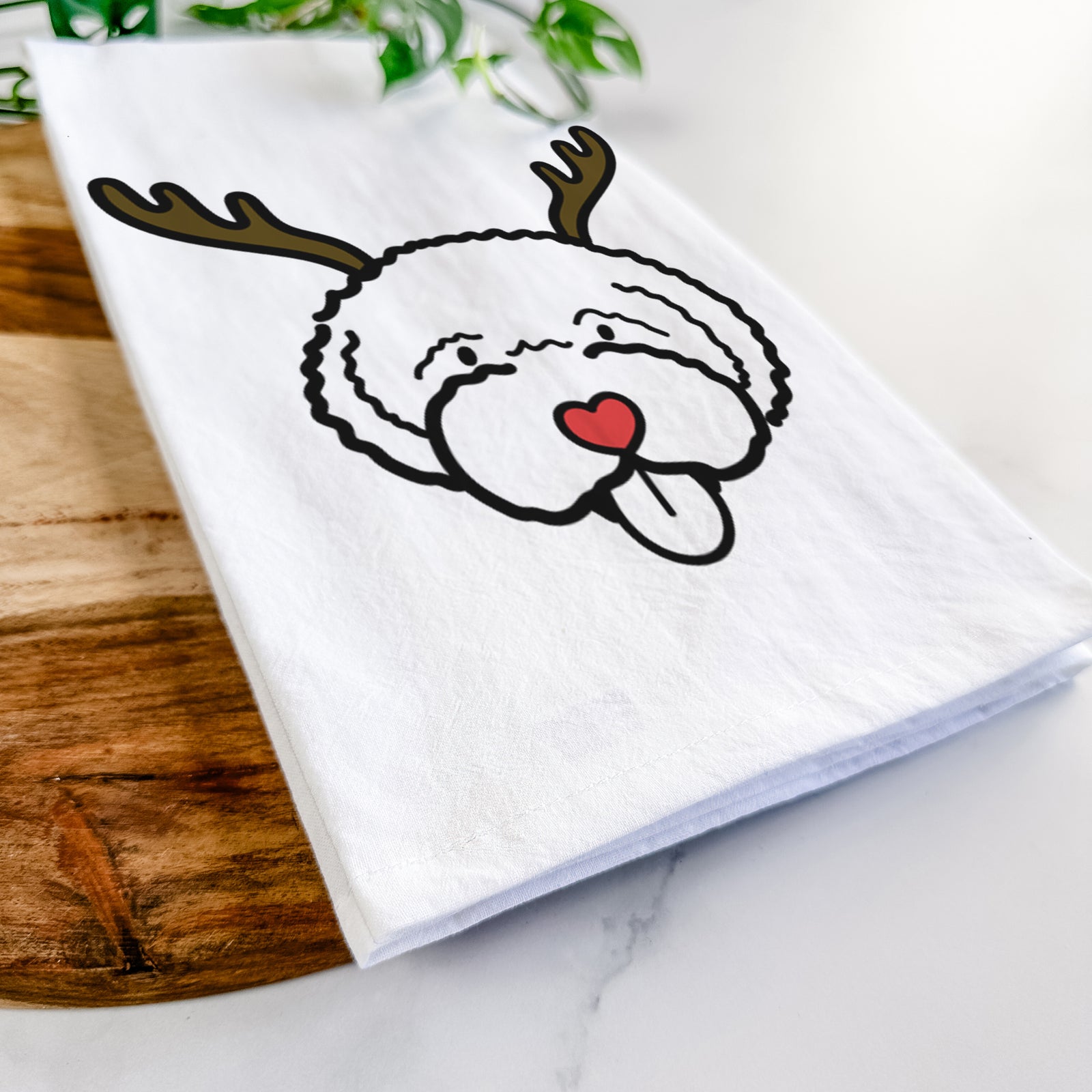 Minimalist line drawing of a Lagotta Romagnolo with reindeer antlers and a red nose on a tea towel