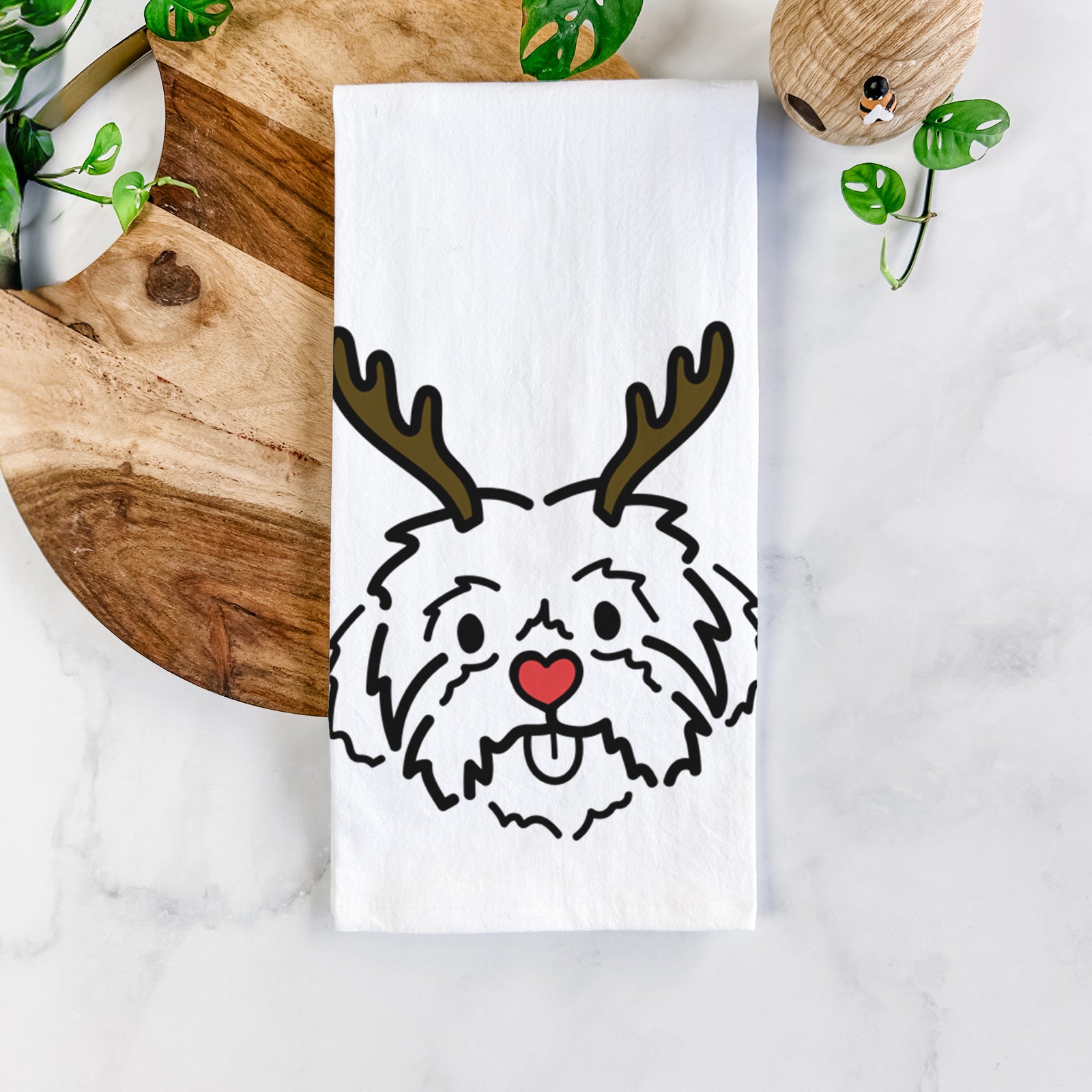 Minimalist line drawing of Leo the Shih Tzu with reindeer antlers and a red nose on a tea towel