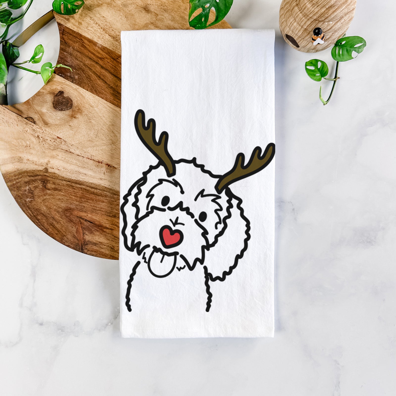 Minimalist line drawing of Mabel the Bernedoodle with reindeer antlers and a red nose on a tea towel