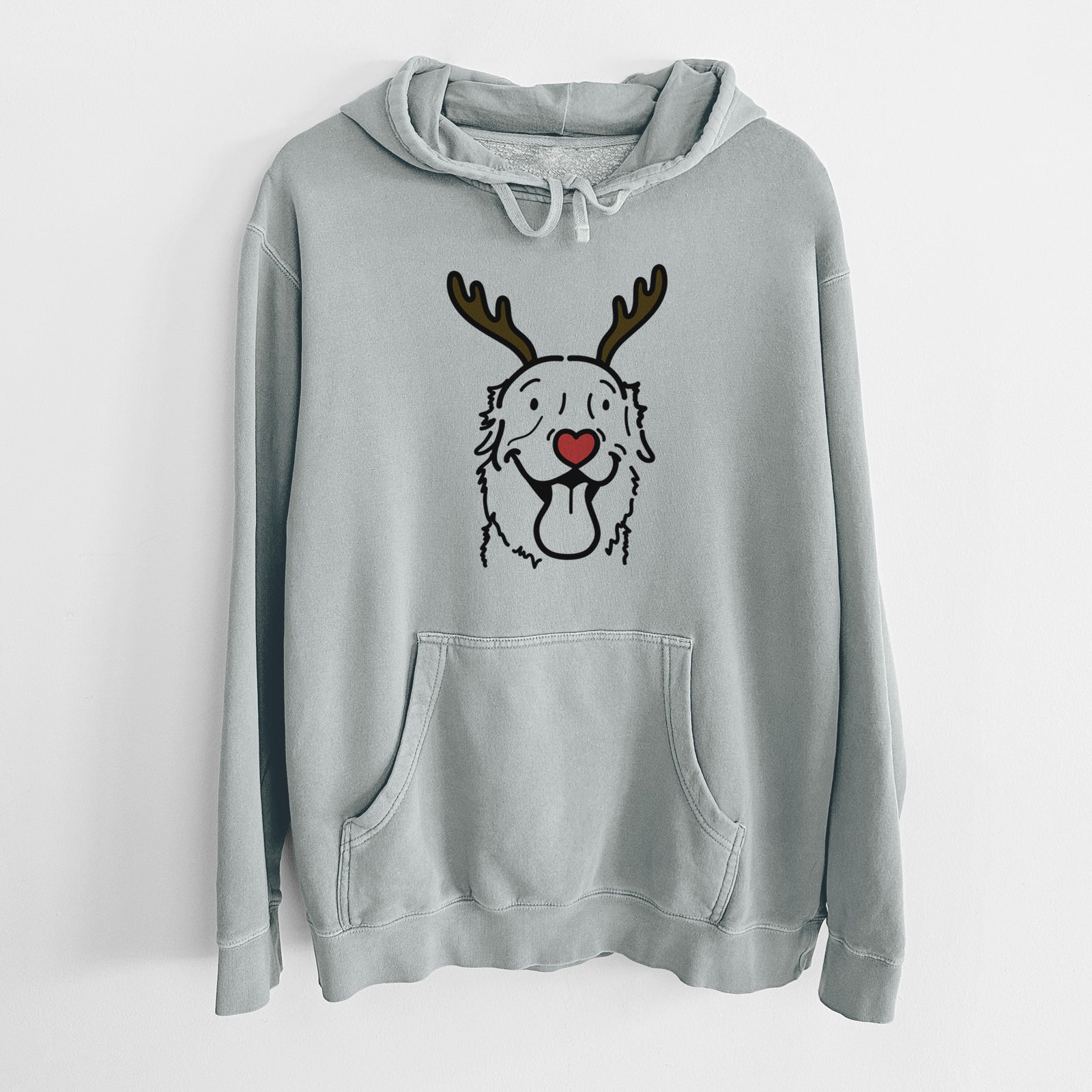 Minimalist line drawing of Maple the Golden Retriever with reindeer antlers and a red nose on a Sage Unisex pigment dyed hoodie