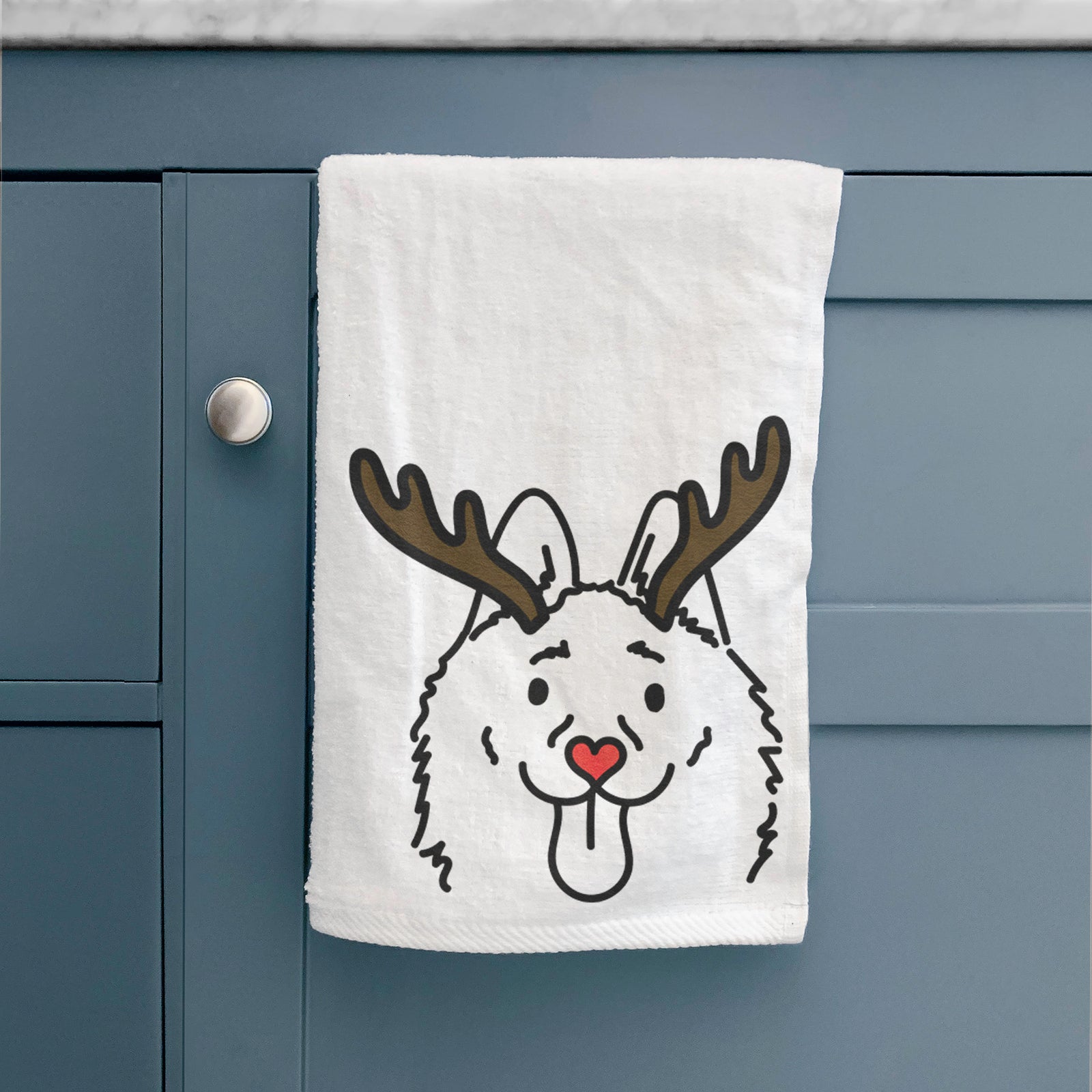Minimalist line drawing of Meeko the Schipperke with reindeer antlers and a red nose on a decorative hand towel