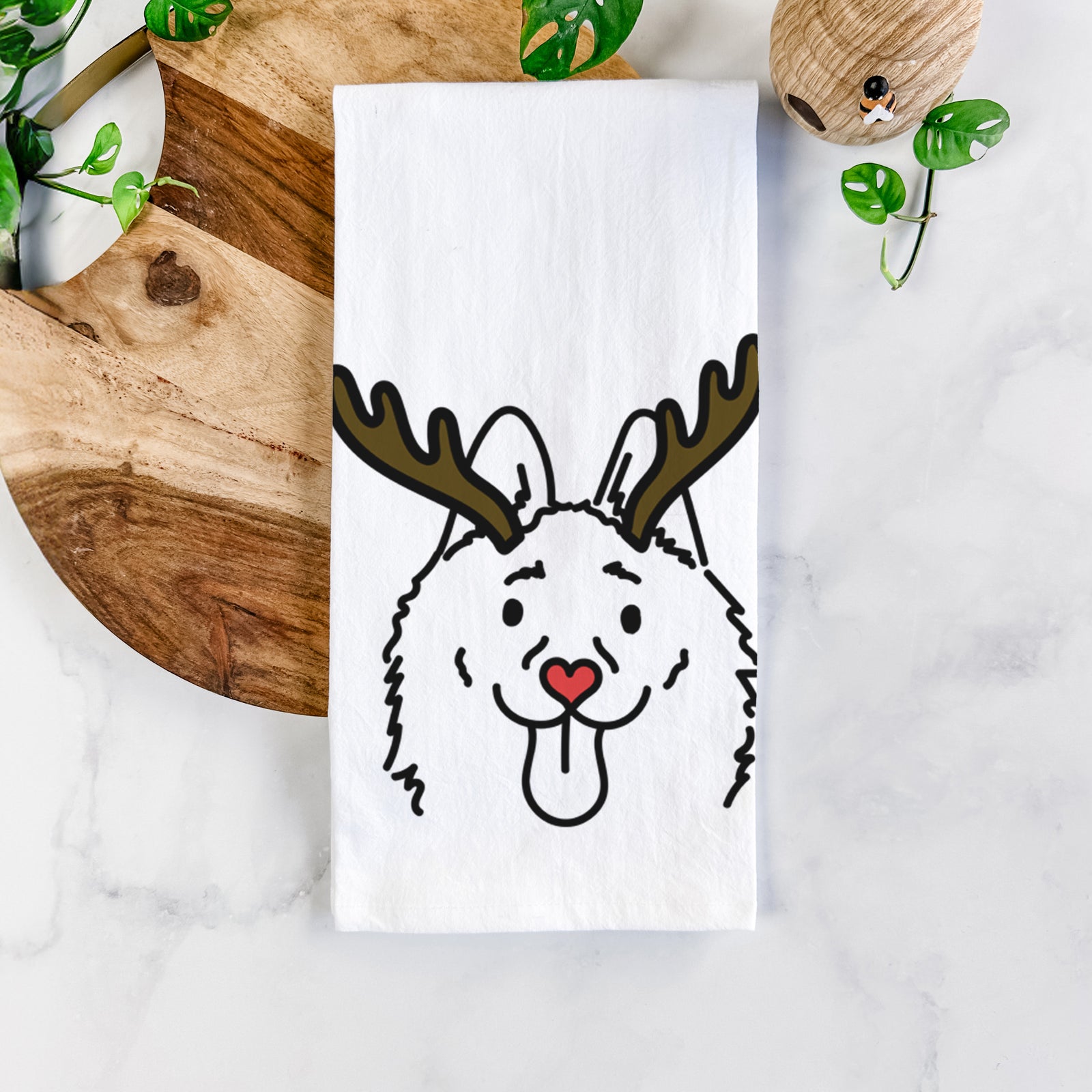 Minimalist line drawing of Meeko the Schipperke with reindeer antlers and a red nose on a tea towel