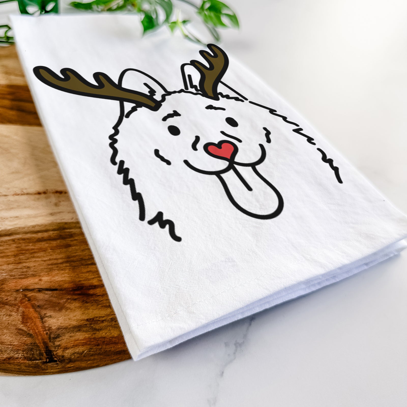 Minimalist line drawing of Meeko the Schipperke with reindeer antlers and a red nose on a tea towel