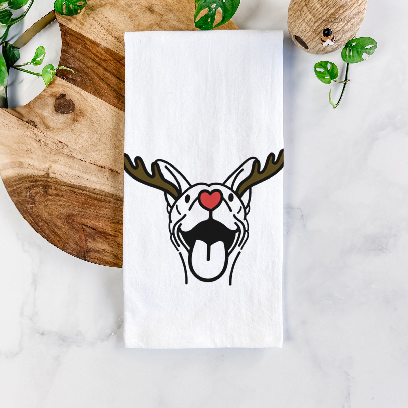 Minimalist line drawing of Merlin the Basenji with reindeer antlers and a red nose on a tea towel