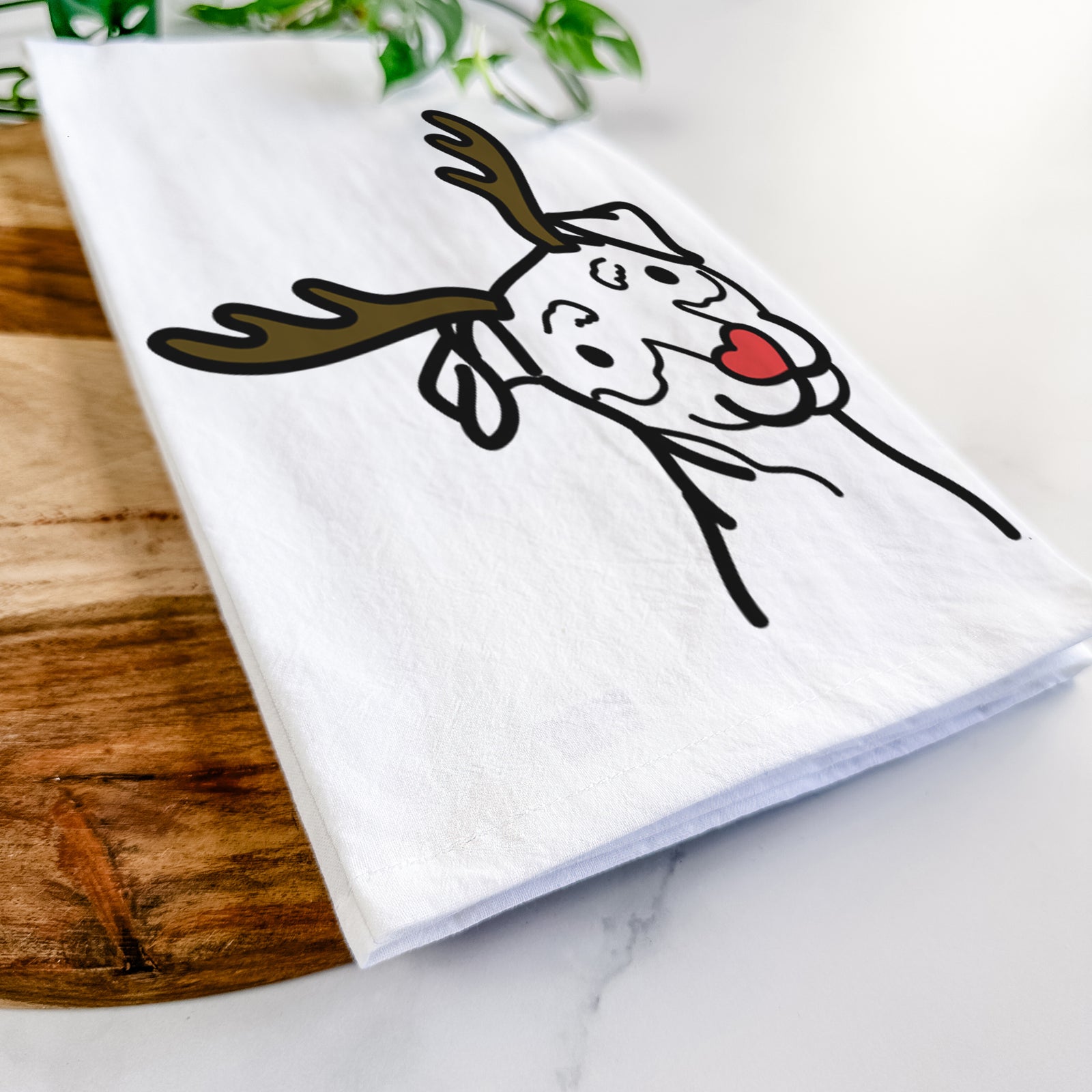 Minimalist line drawing of a Mini Pinscher with reindeer antlers and a red nose on a tea towel