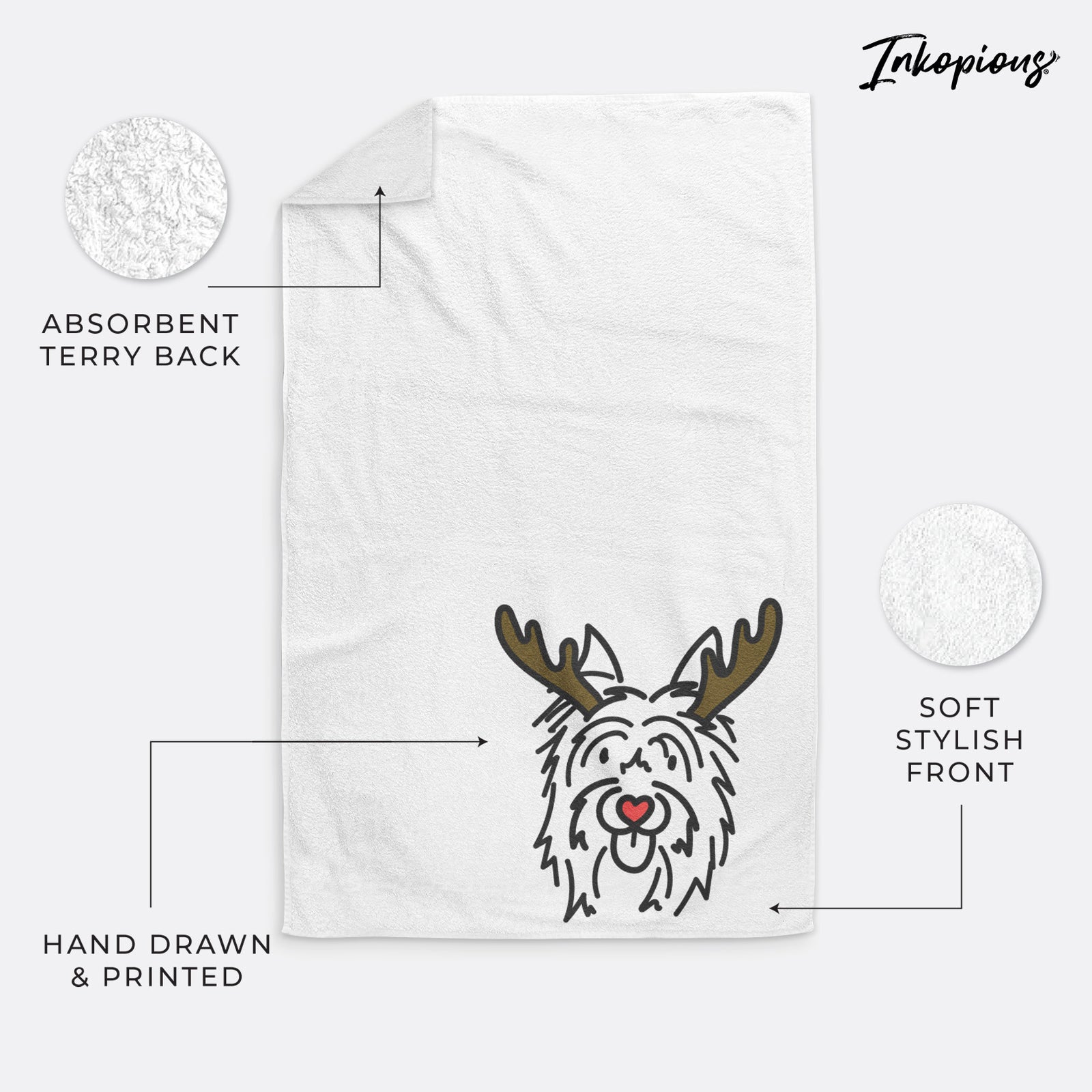 Minimalist line drawing of Monty the Silky Terrier with reindeer antlers and a red nose on a hand towel